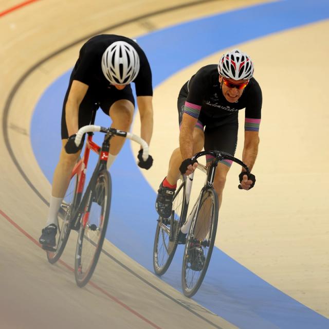 Two adult riders on the banking during a session