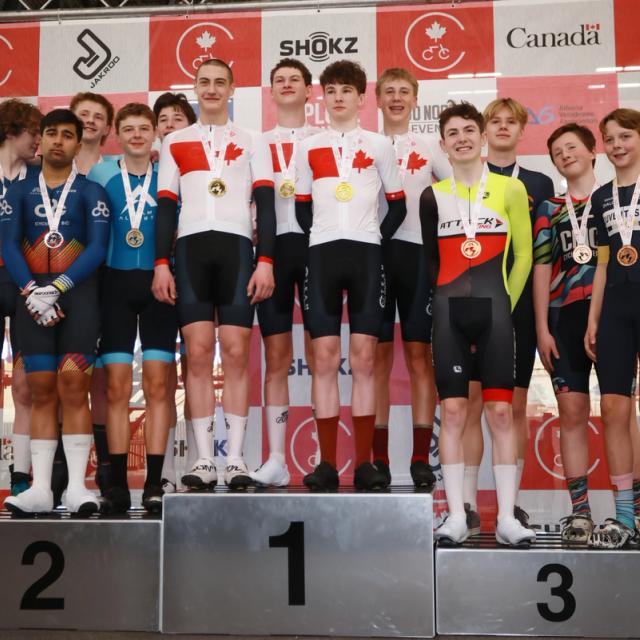 Medallists on the podium in front of the sponsor backdrop