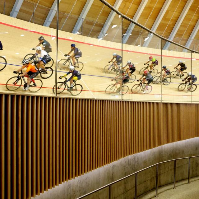 Riders on the banking against the timber wall