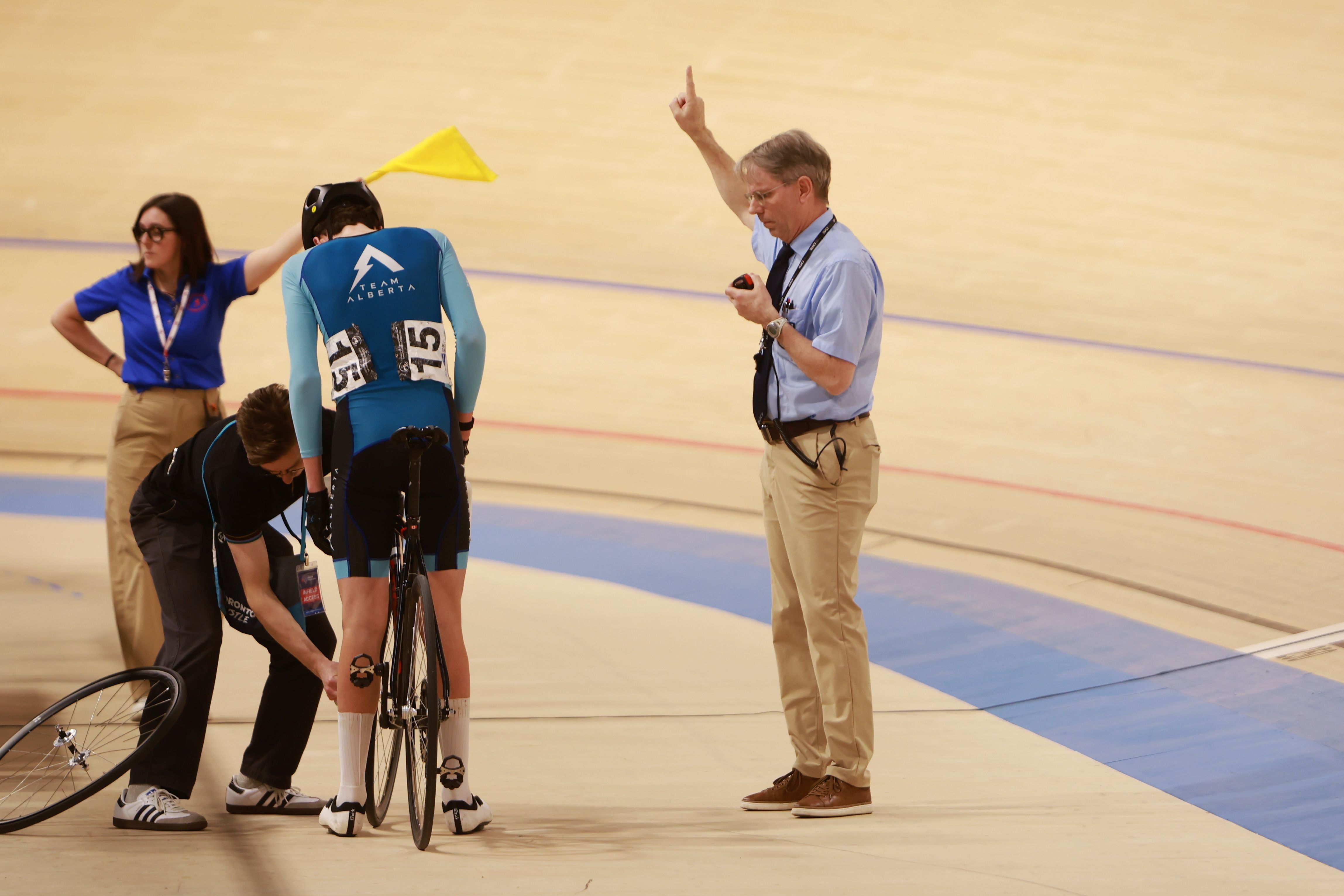 Officials and volunteers assist riders at the start line