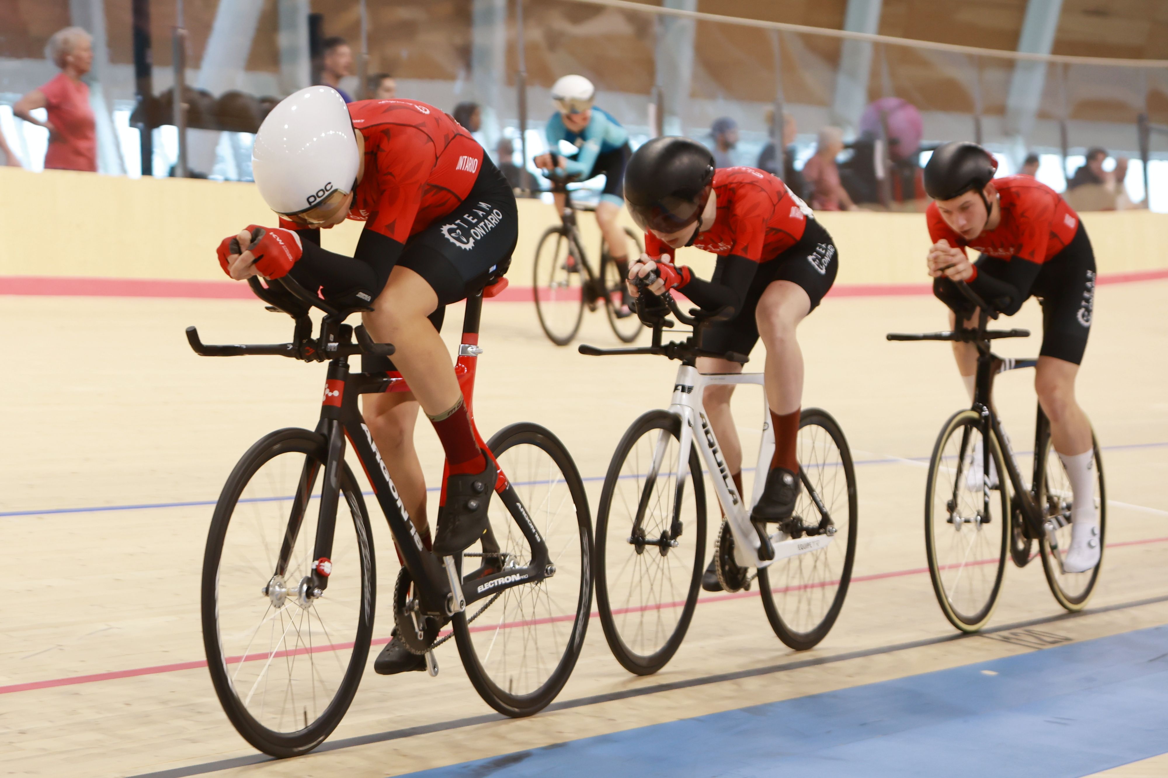 Pursuit teams racing on the Alberta Velodrome track