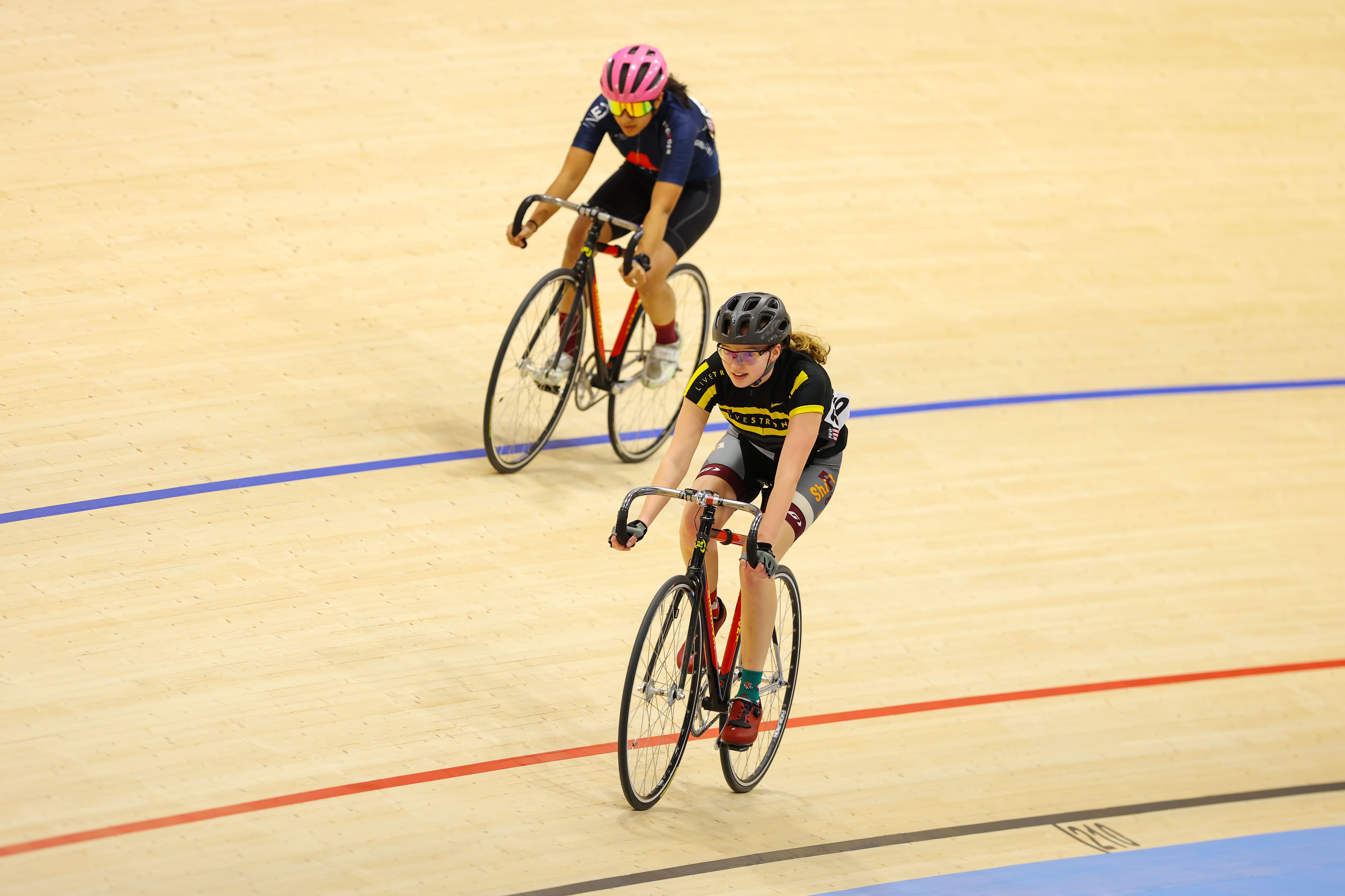 Two riders on the track during an introductory session at the Alberta Velodrome