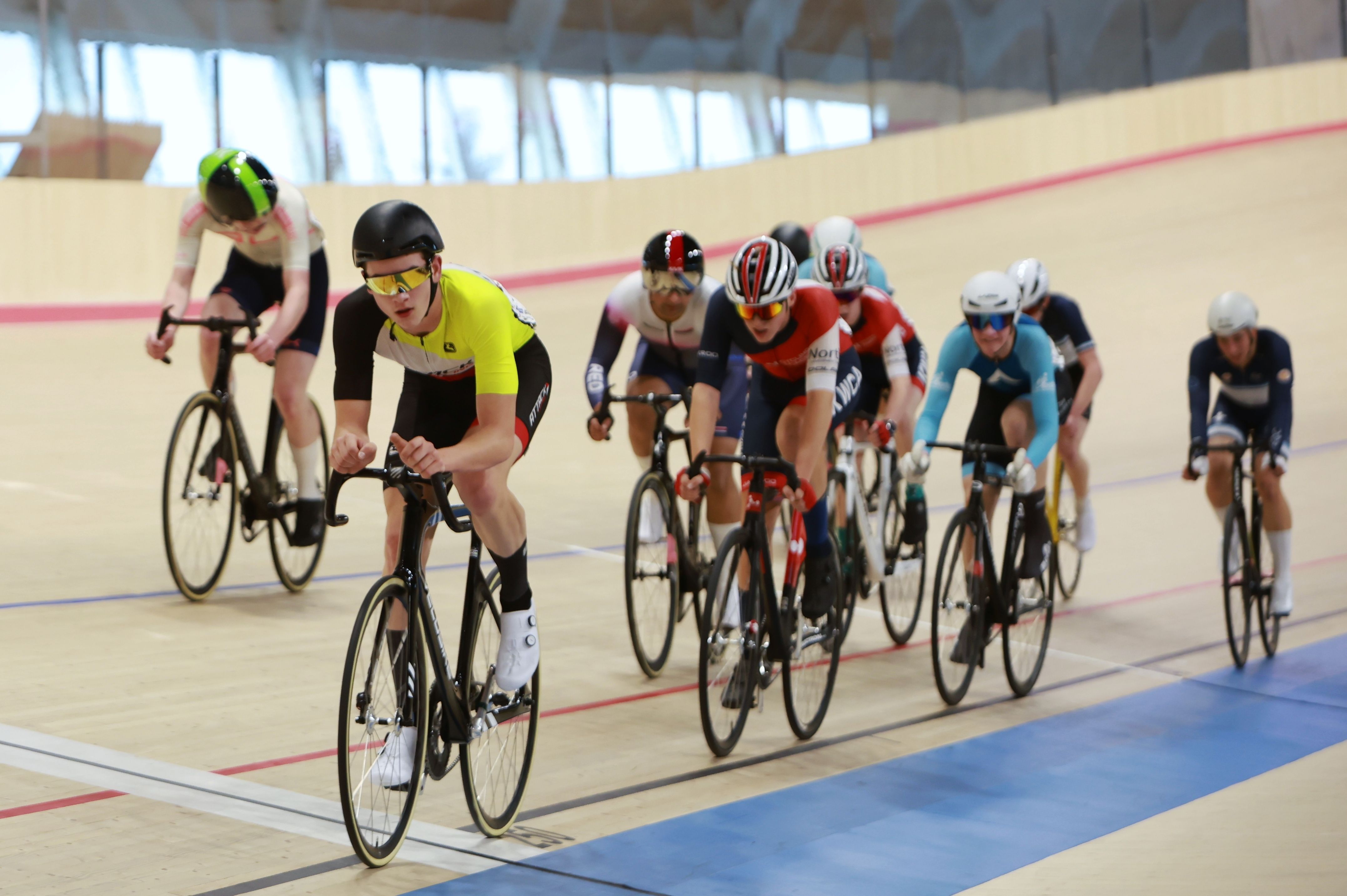 Two riders sprint side by side on the banking