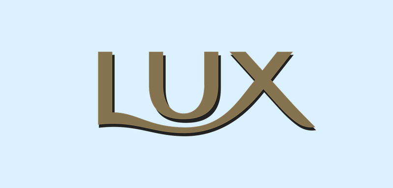 Lux logo in gold lettering with black shadow