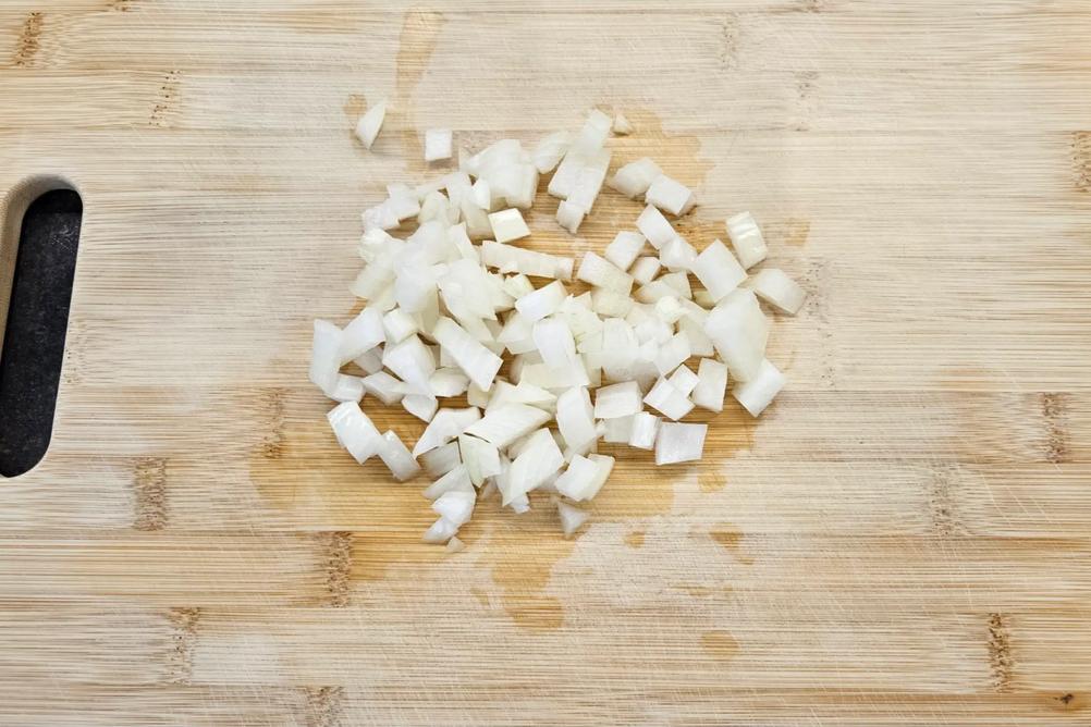 Finely chopped onion prepared for cooking.