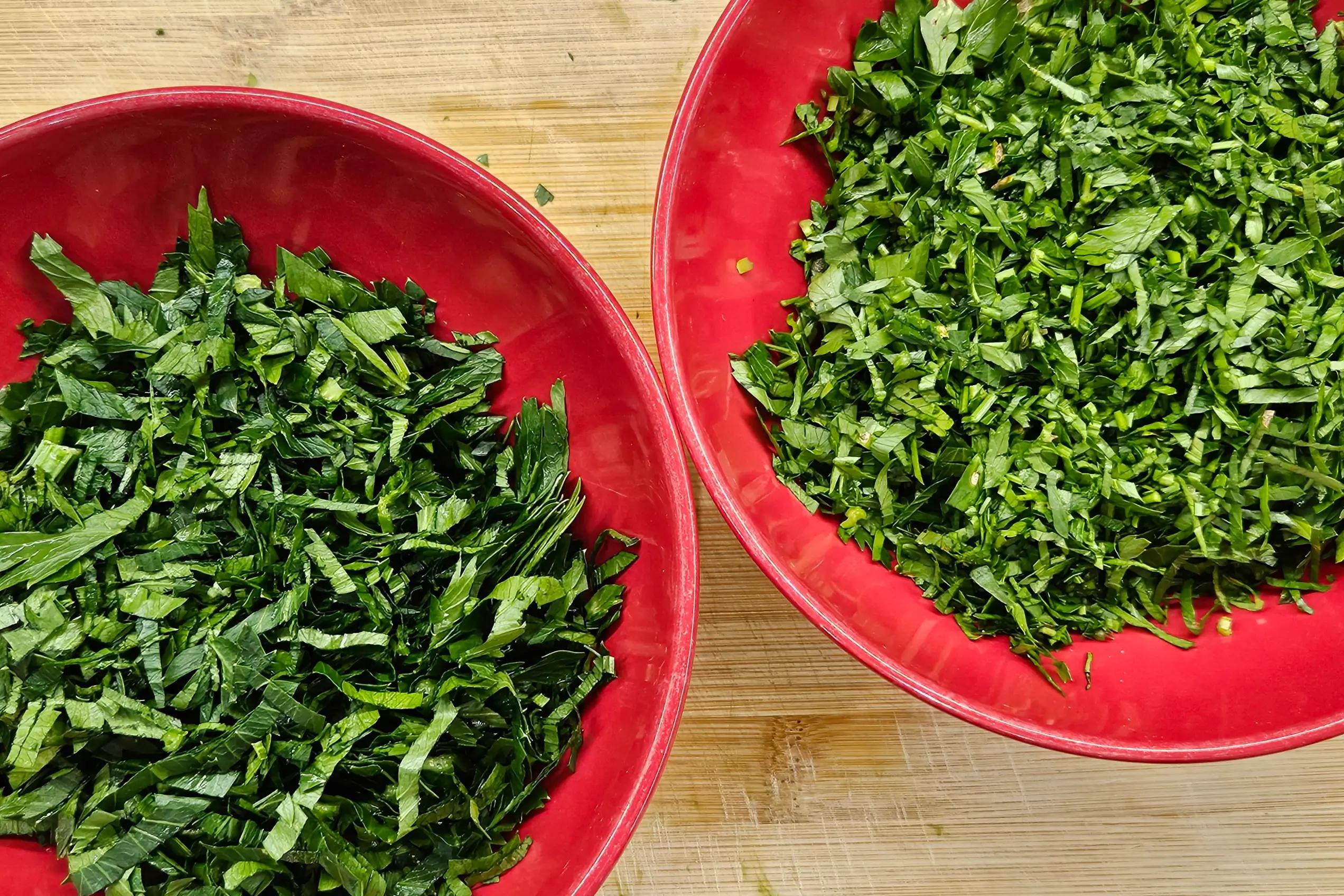 Finely chopped fresh celery greens, parsley, and cilantro on a kitchen counter.