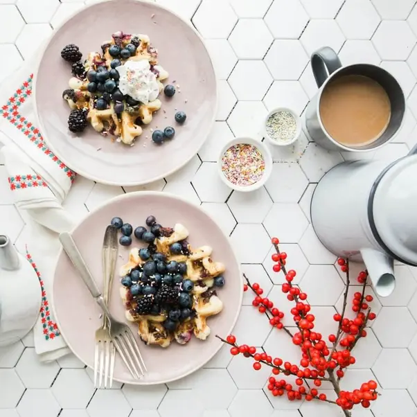 Belgian waffles with berries, served as a breakfast for two.