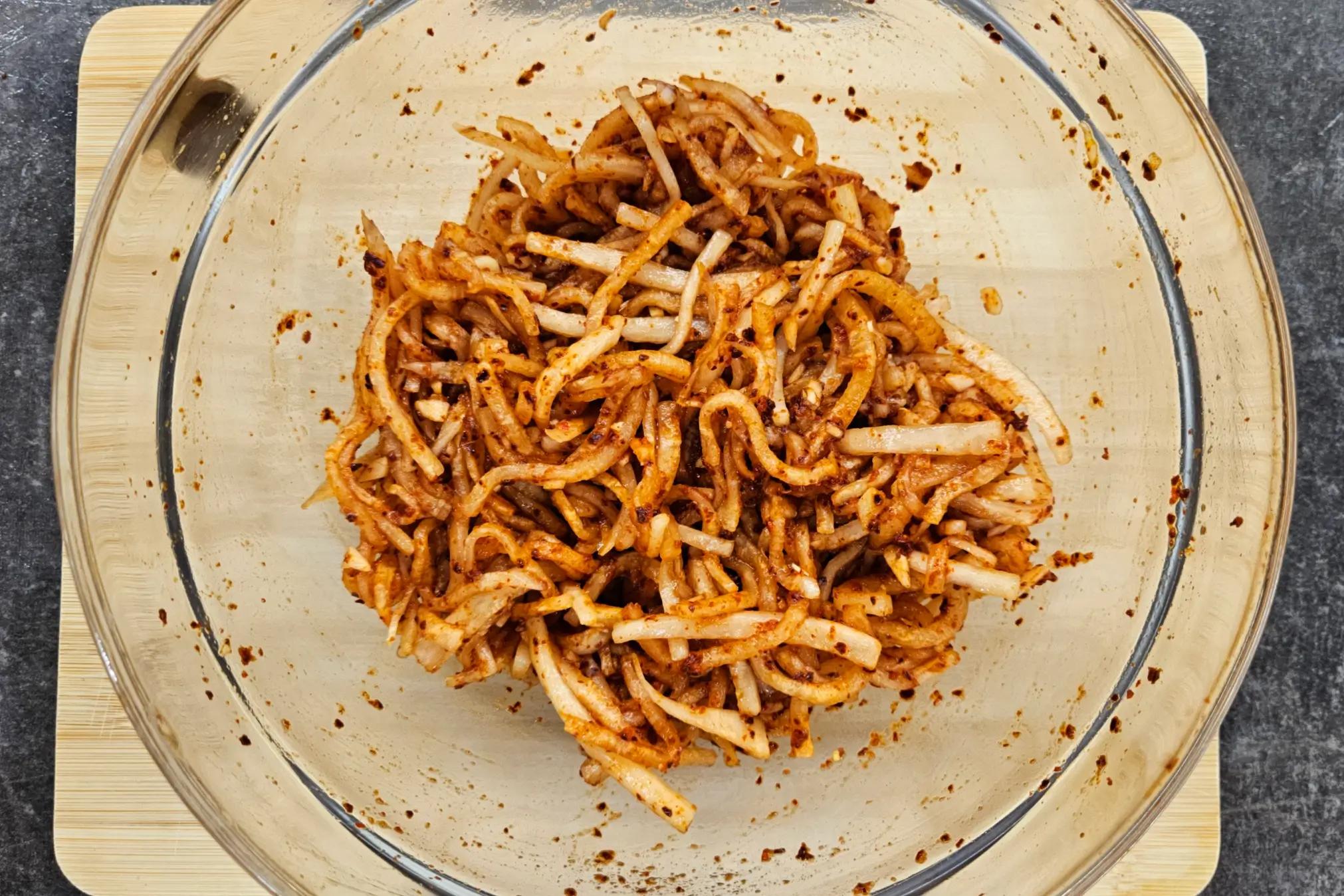 Daikon radish strips seasoned with spices, fish sauce, and rice vinegar.