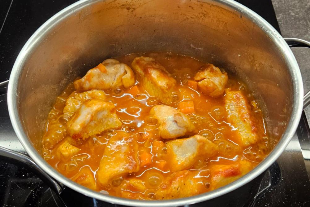 Вливаємо гарячу воду в сковороду для тушкування індички.