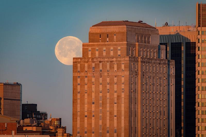 Early morning setting moon in Boston city skyline