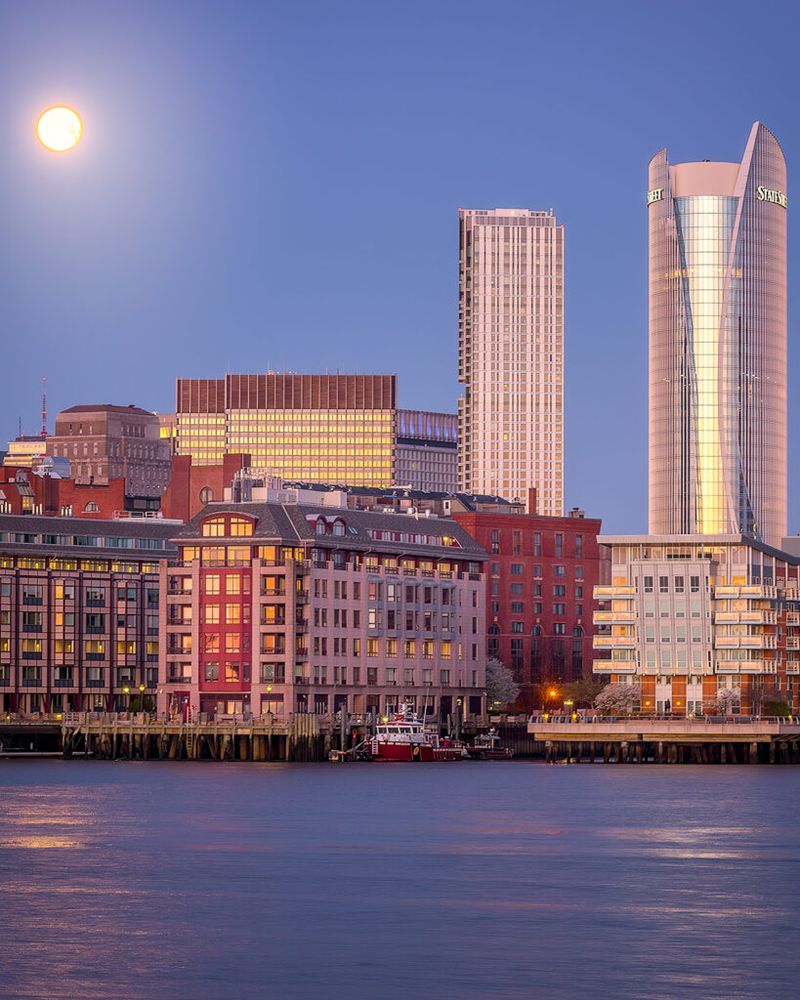Early morning setting moon in Chelsea against the Boston skyline