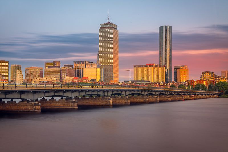 Boston's Prudential and John Hancock towers agains smooth long exposure of the Charles River