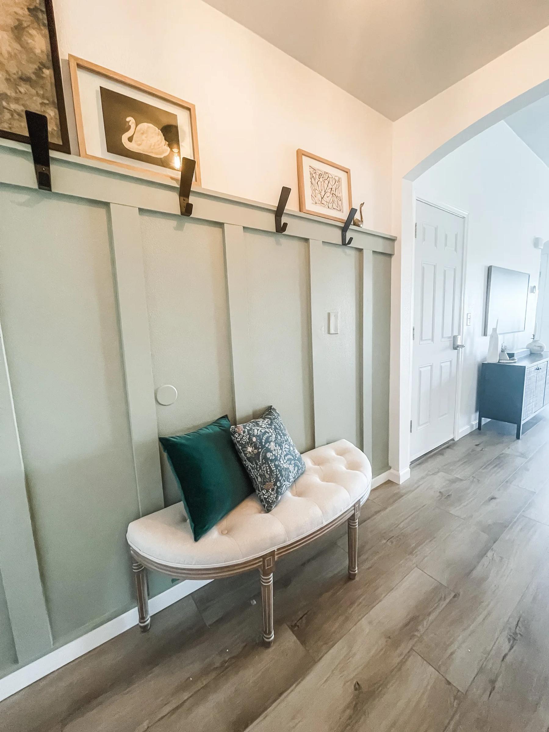 A slatted accent wall with a wood decor ledge in an entryway