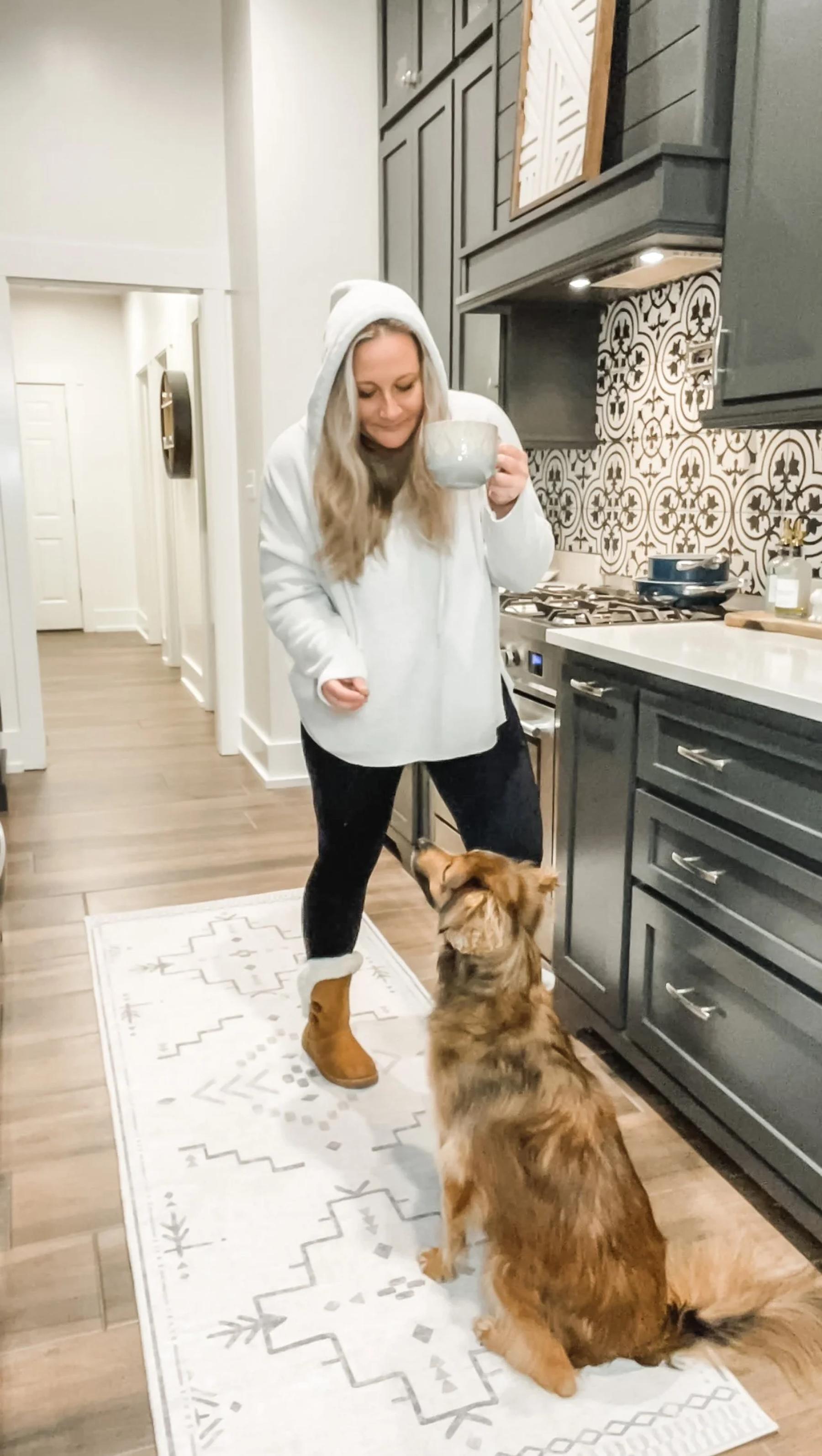 A neutral washable Tumble rug in a bright kitchen with a dog
