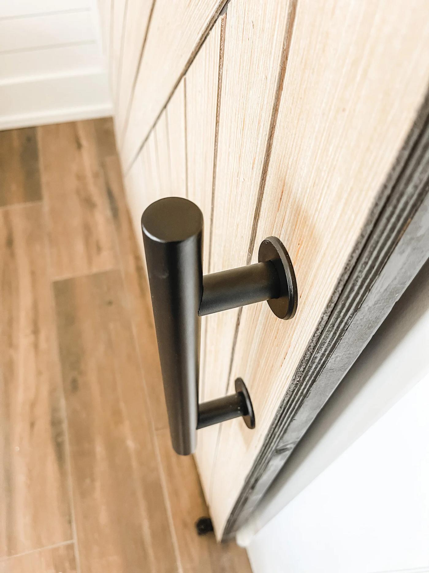 The matte-black pull and floor guide once everything was mounted
