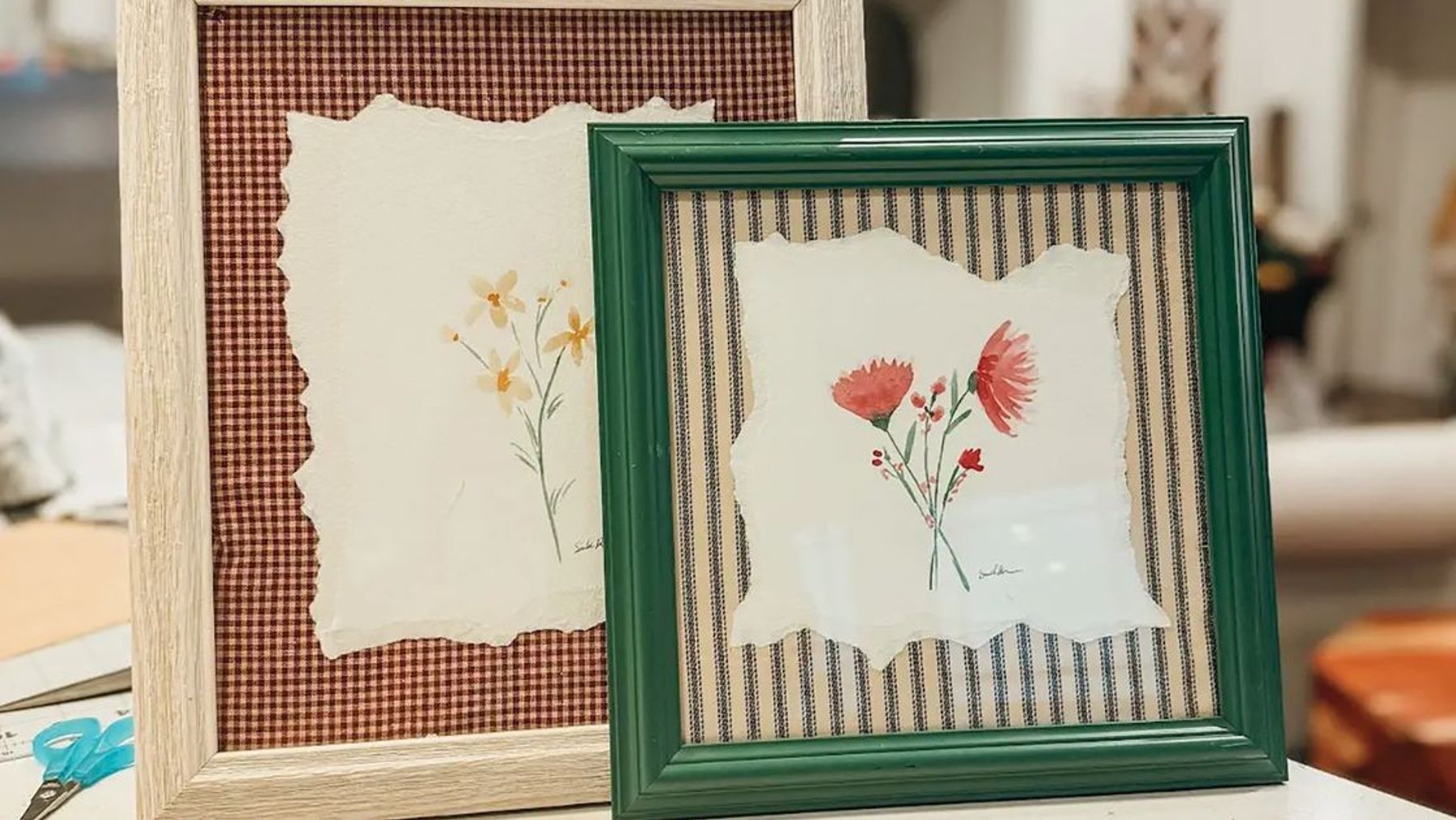 Thrifted picture frames filled with fabric backing and small watercolor florals