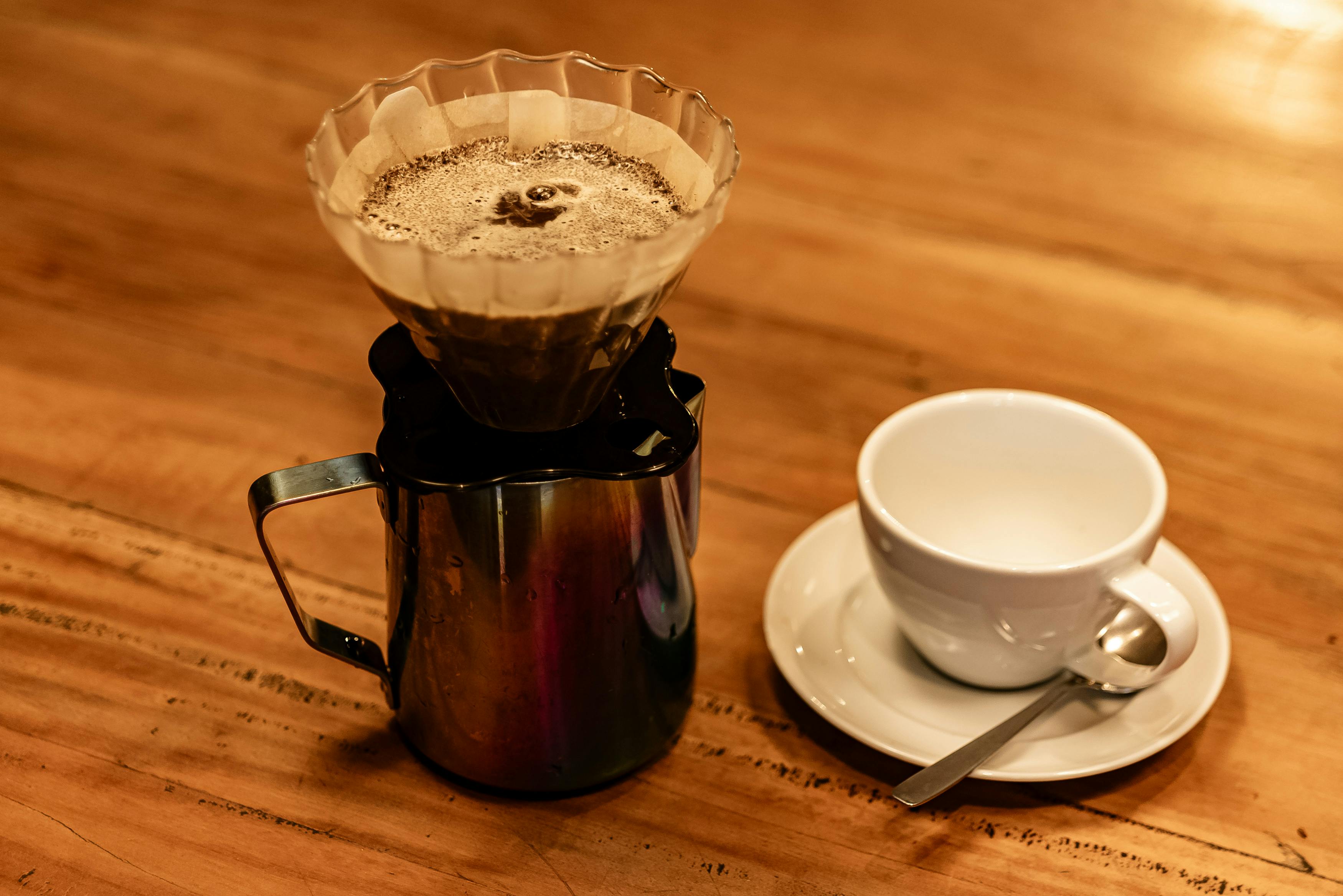 Roasted coffee beans inside a metal coffee roaster.