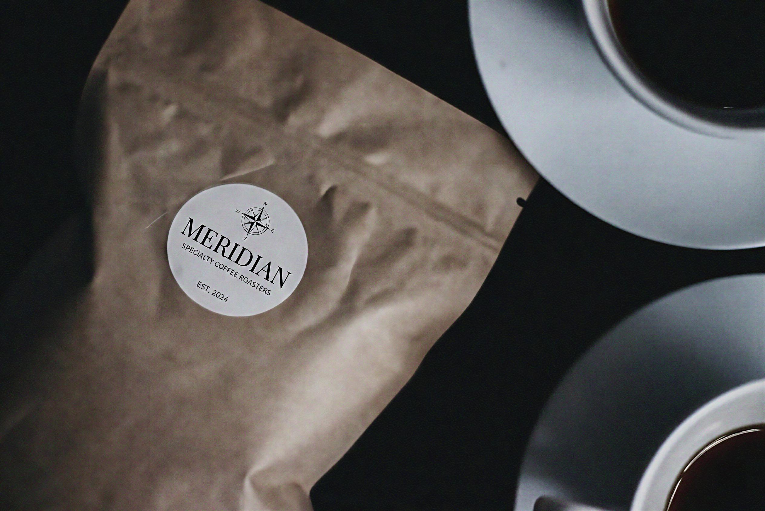 Meridian specialty coffee kraft bag with two cups of black coffee