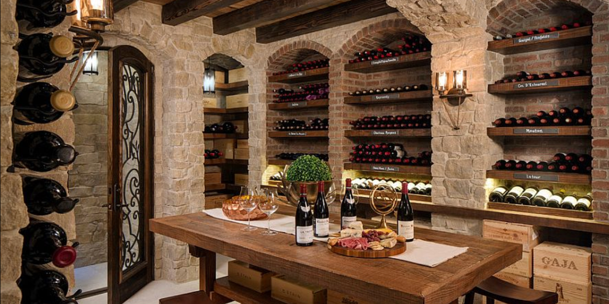 Home wine room with winery-inspired color palette featuring warm neutrals, rich wood, and ambient lighting
