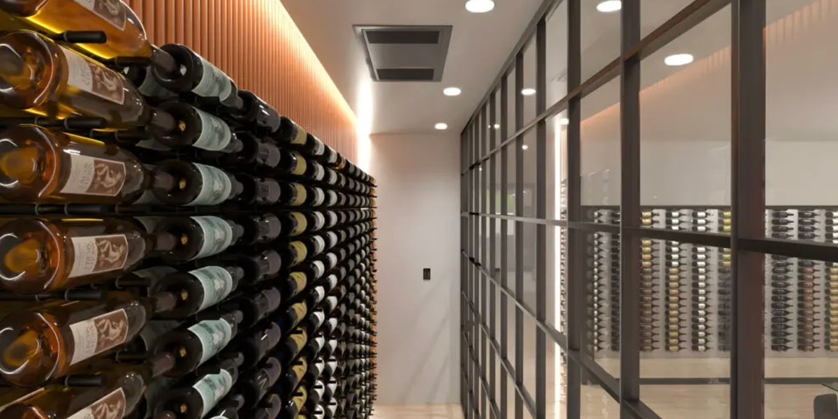 Wine cellar cooling unit installed above custom wine racks to maintain proper temperature and humidity