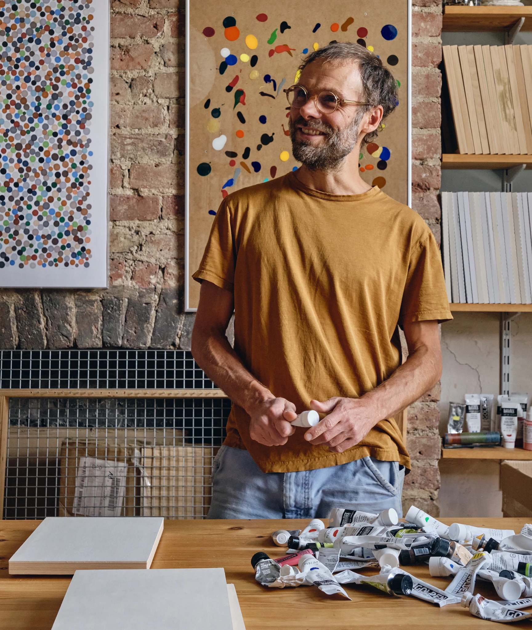 Artist Daniel Eatock in his London art studio among one of his felt-tip prints and a clip frame painting.