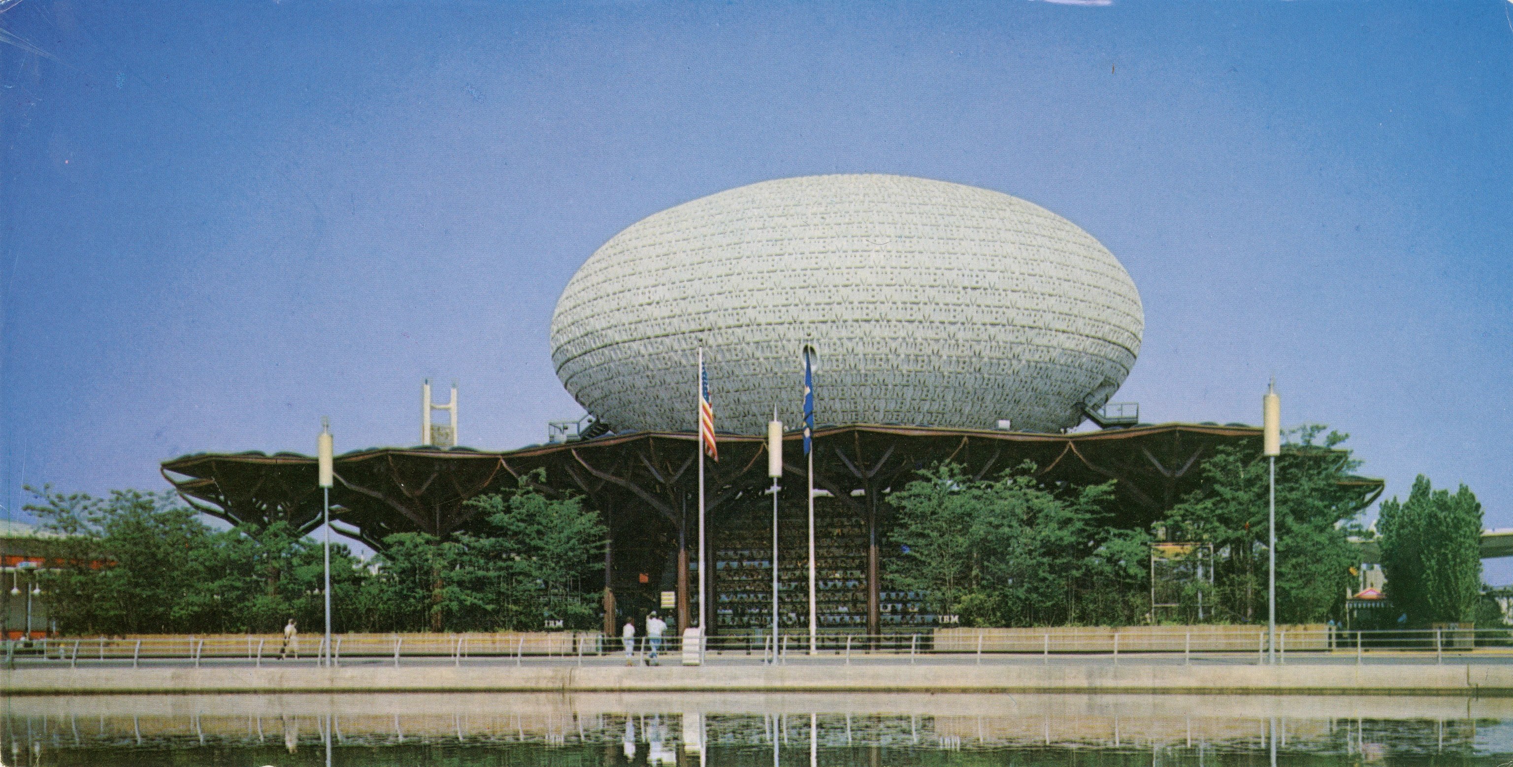 Postcard of the 1964 New York World’s Fair IBM Pavilion featuring steel “trees” encircling a large “egg” shaped theatre.