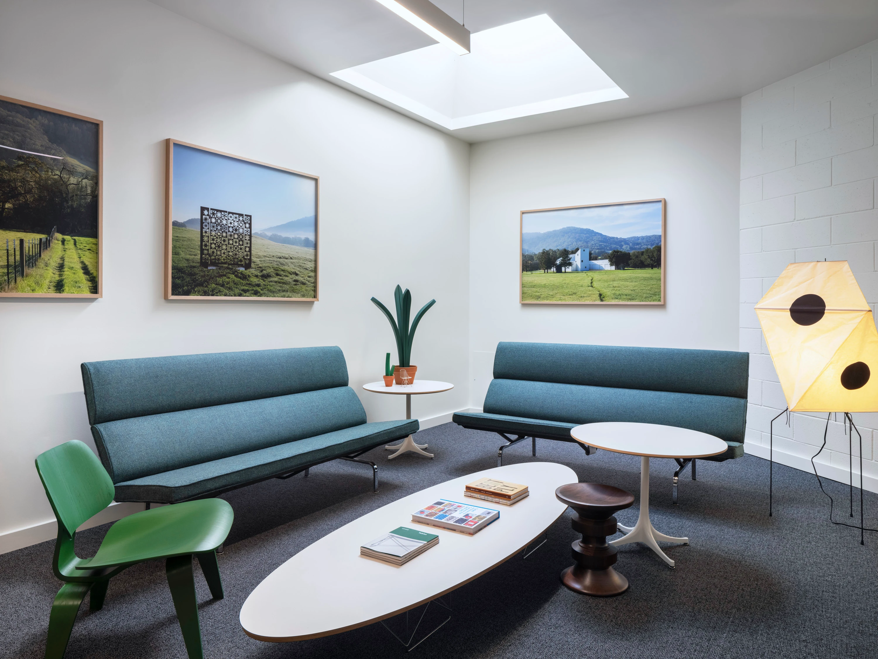 A lounge space with blue couches at the Eames Institute offices in Richmond, CA