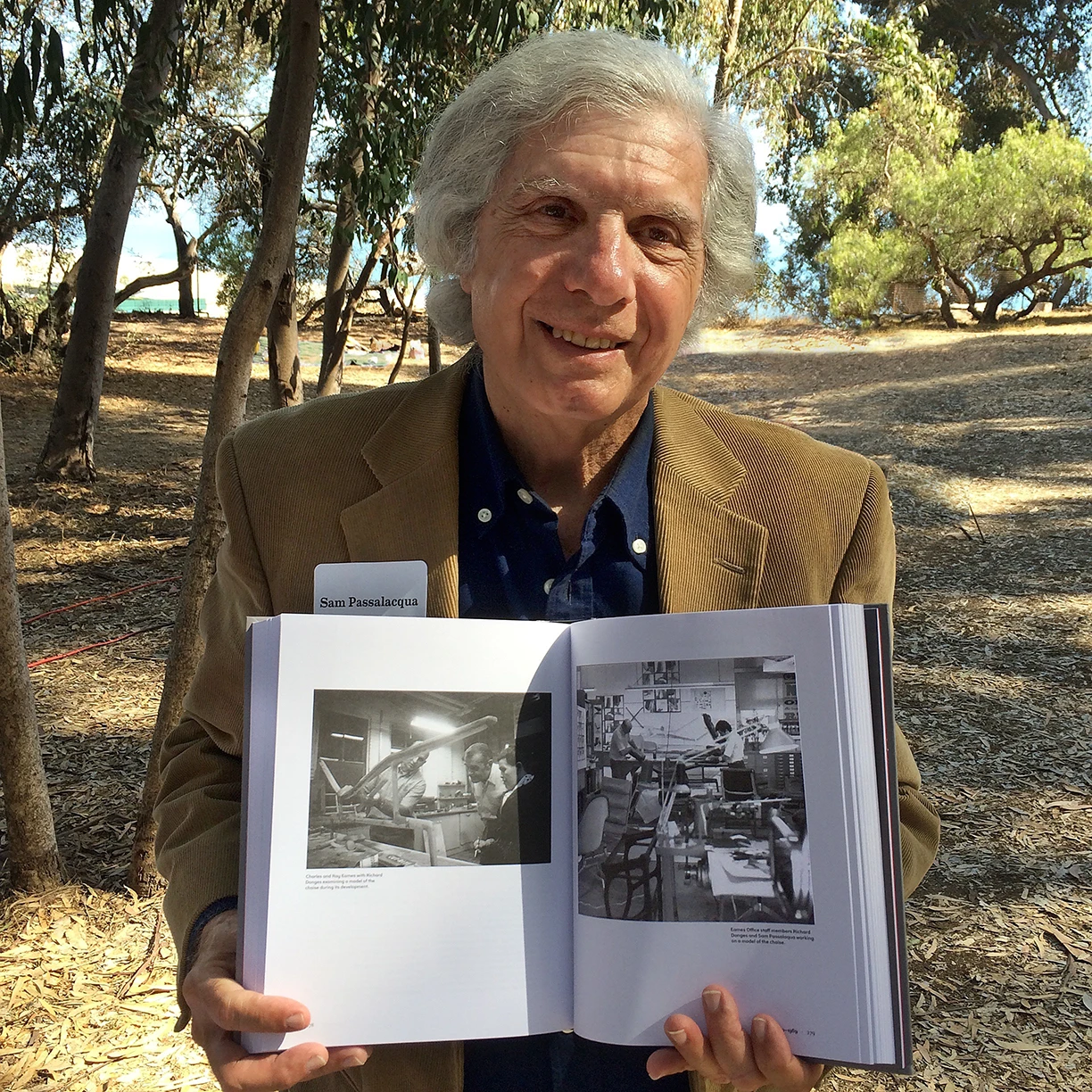 Sam Passalacqua holding a copy of An Eames Anthology out side the Eames house, case study house 8.