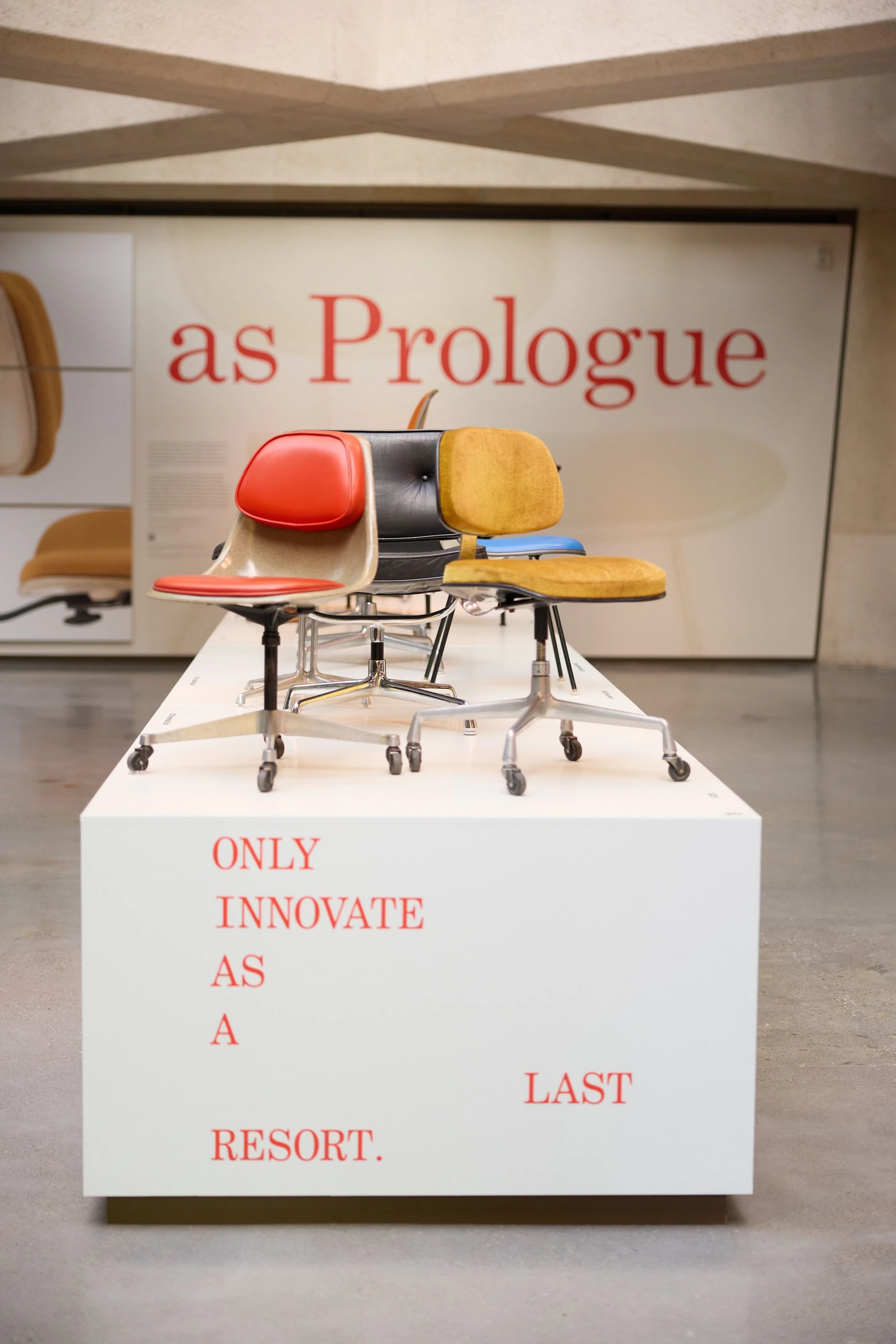 Eames chairs on a large platform featuring a quote from Charles Eames as part of the Past as Prologue exhibition in San Francisco.