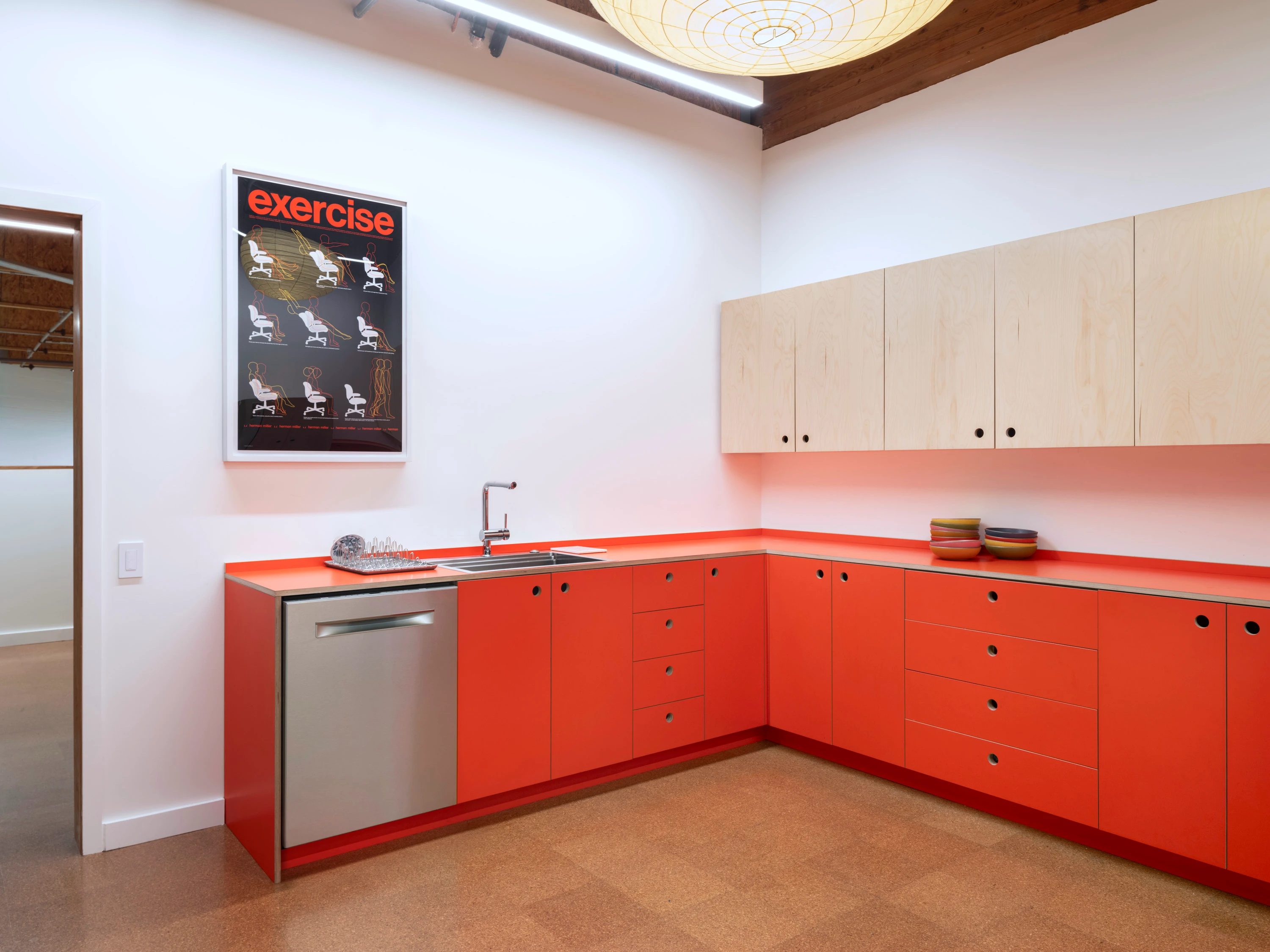 The orange kitchen at the Eames Institute's Richmond offices