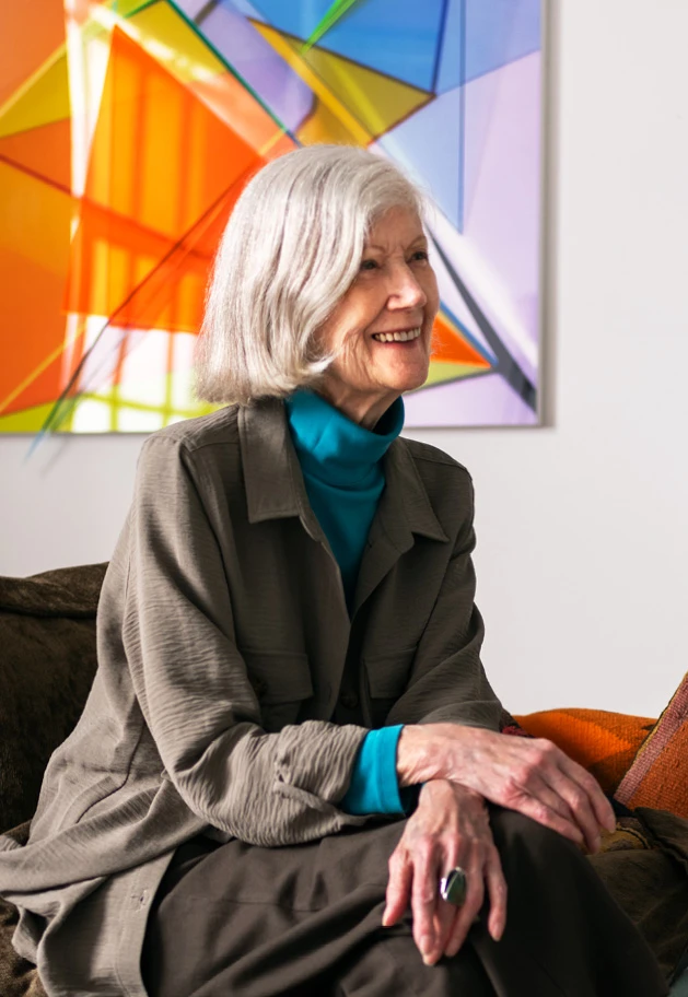Chicago artist Barbara Kasten seated with her piece Progression Seven, in the background.