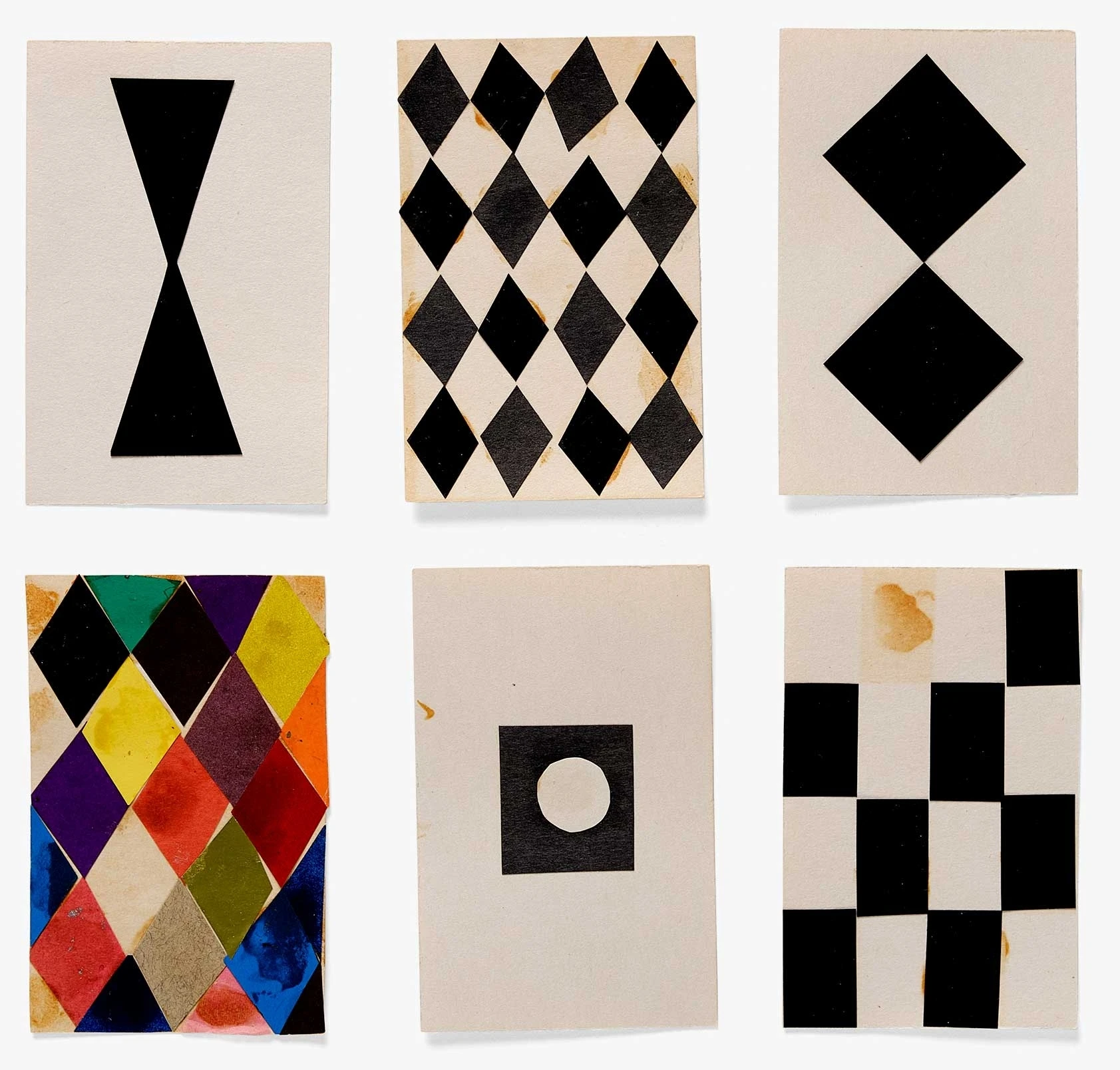 Diamond and checkerboard patterned Eames House of Cards mockups in black and white, and one diamond card with many colors.