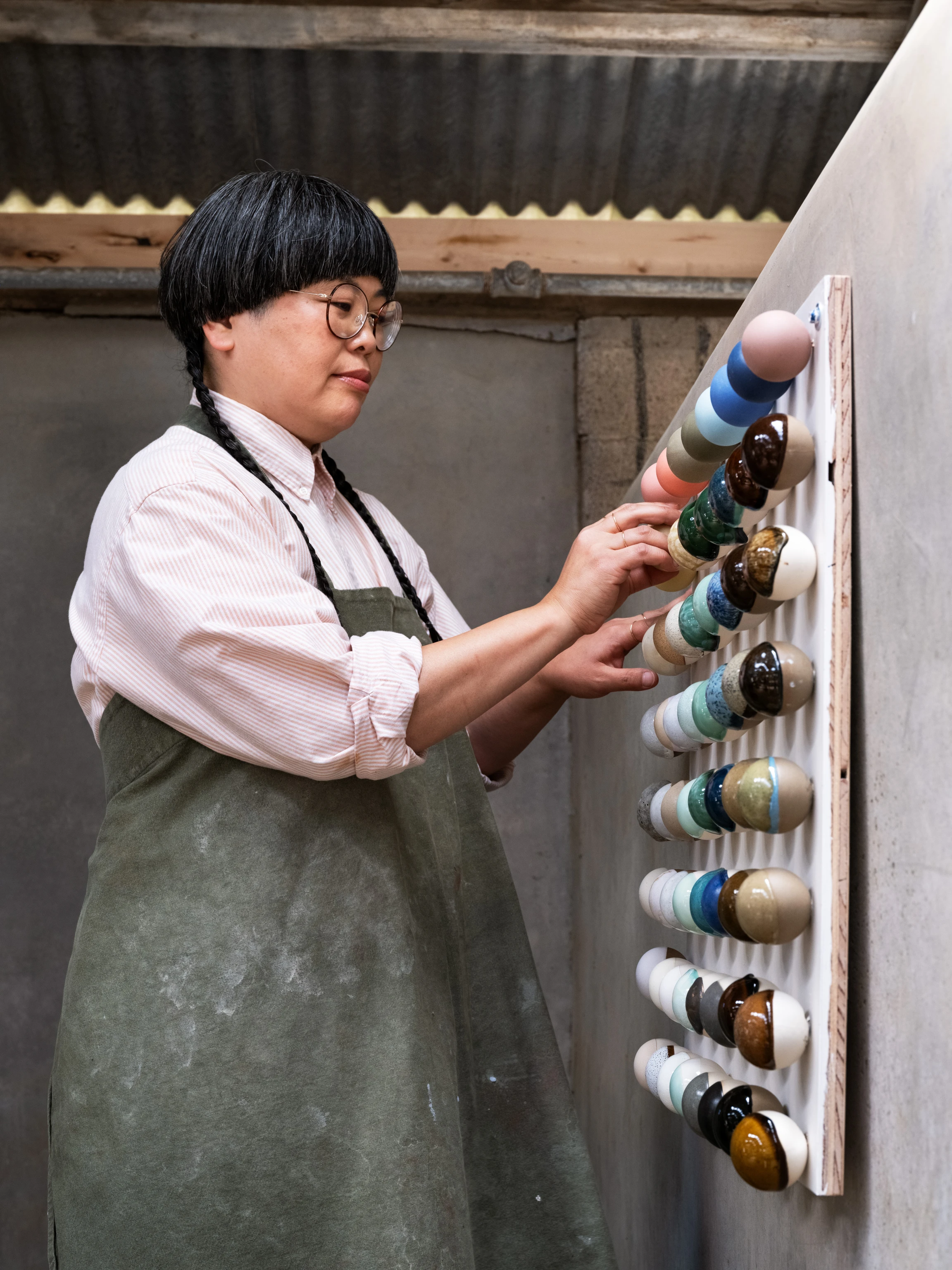 An artist in residency at the Eames Ranch Studios hangs dyed papers to dry on a clothesline.