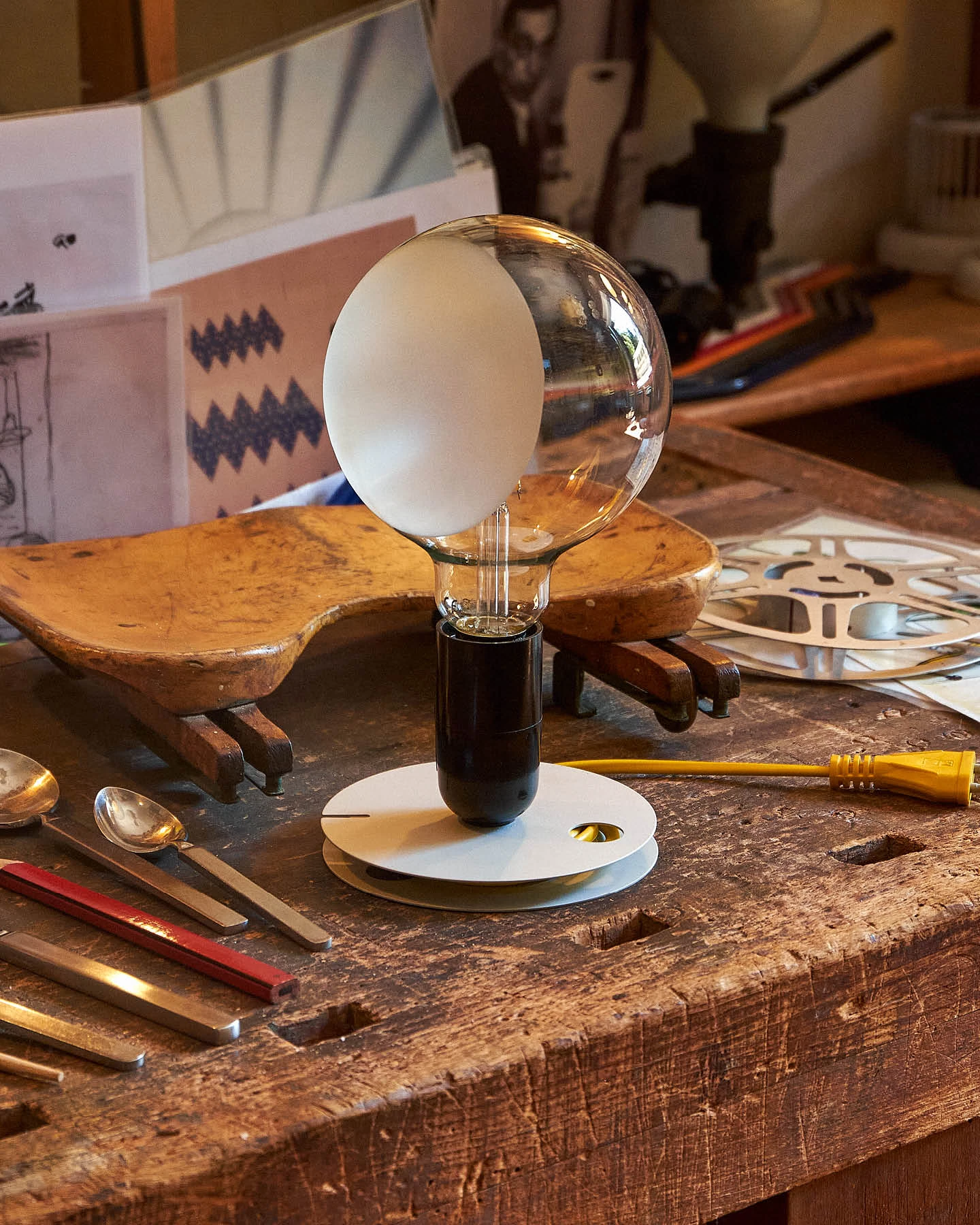 Lampadina table lamp designed by Achille Castiglioni on a worktable at the designer’s studio in Milan.