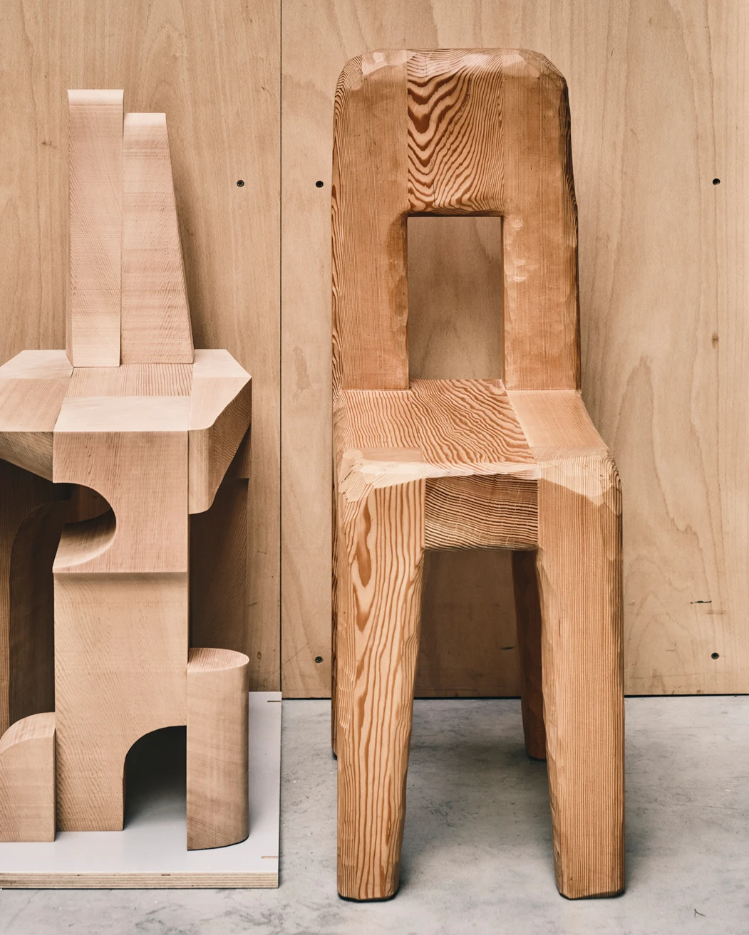 One of furniture designer Max Lamb’s completed 6x8 Chairs (left) next to a Douglas Fir Chair originally designed for Acne Studios’ Stockholm headquarters.