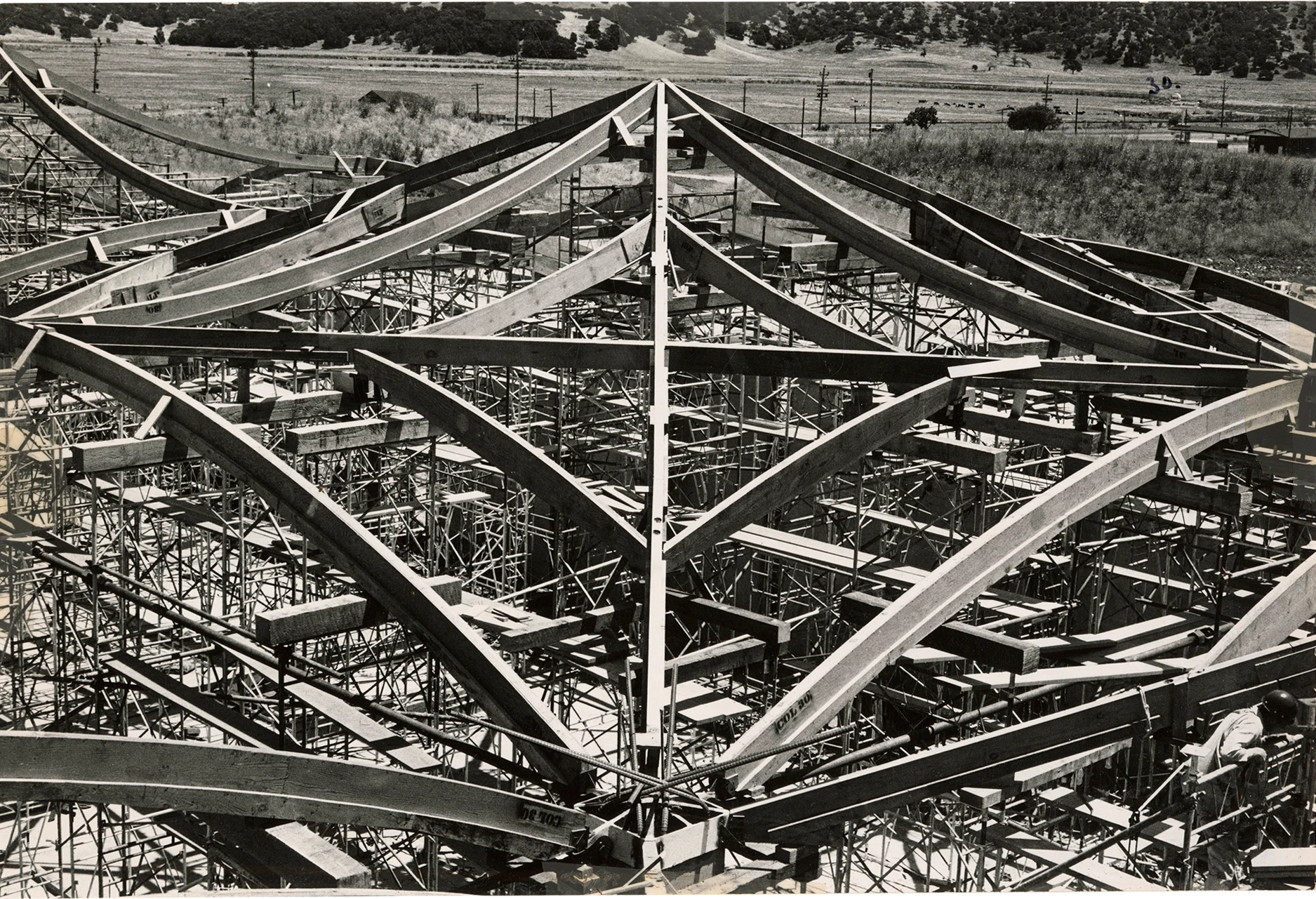 Angled front view of a hyperbolic paraboloid roof segment formwork in the process of being assembled.