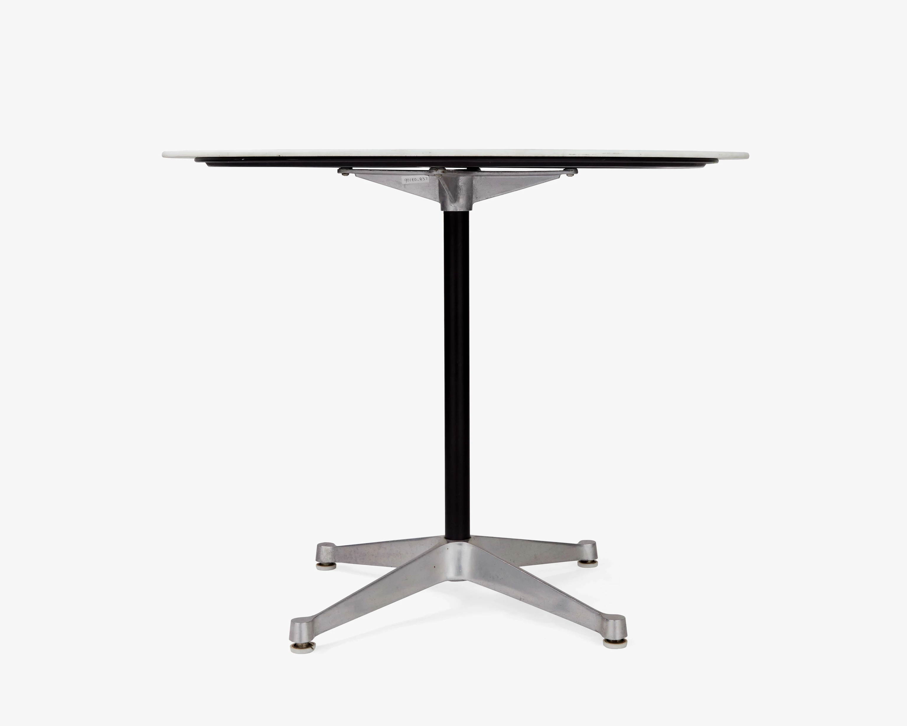 Side view of the Eames 692 Dining Table with round white glass top and cast-aluminum pedestal base.