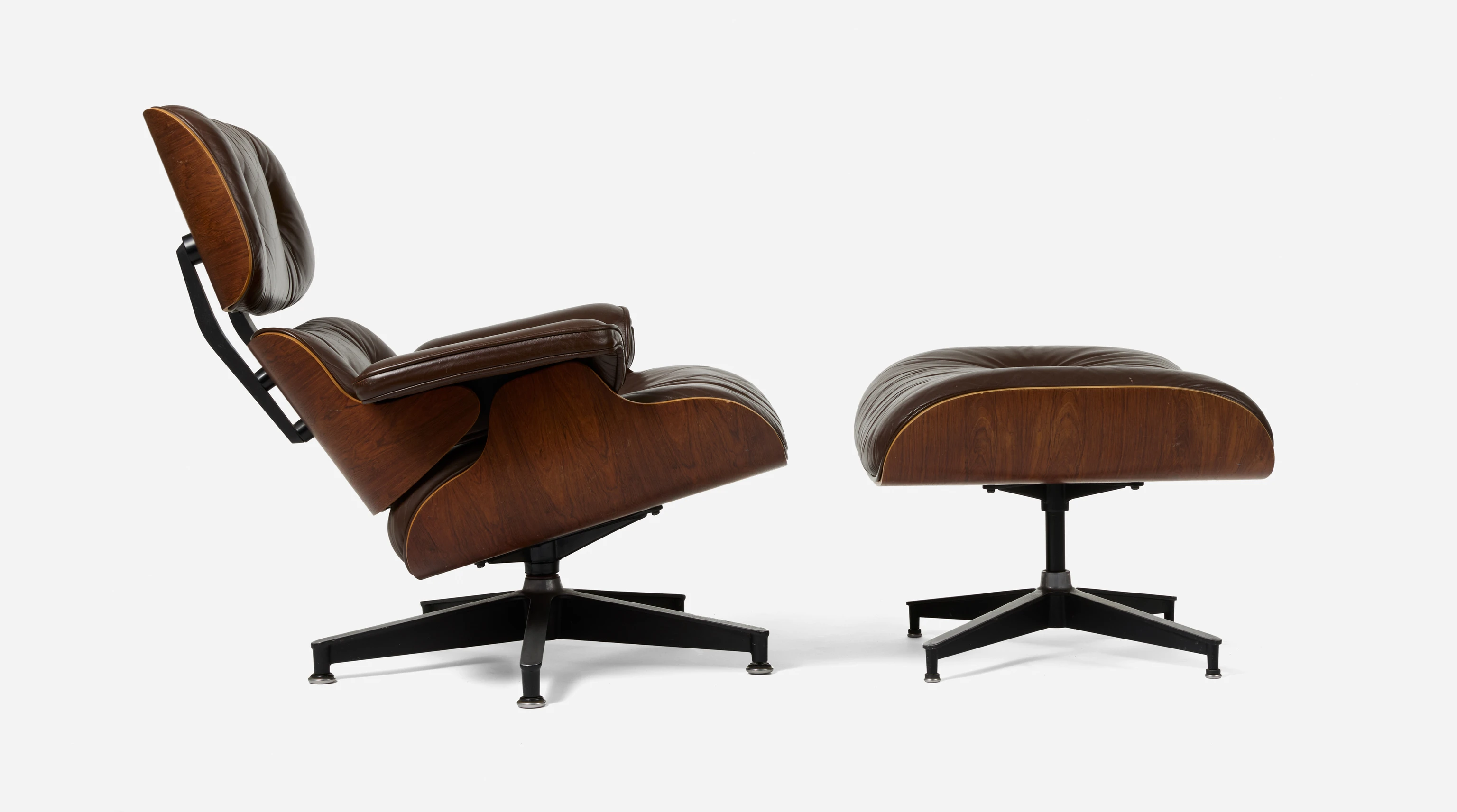 Side view of a brown leather and Brazilian rosewood Eames Lounge Chair and Ottoman that was given to an Eames family member.