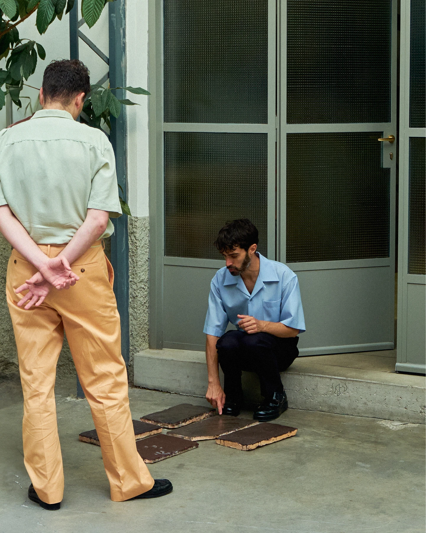 Andrea Trimarchi and Simone Farresin of design studio Formafantasma reviewing brown ceramic glaze samples.