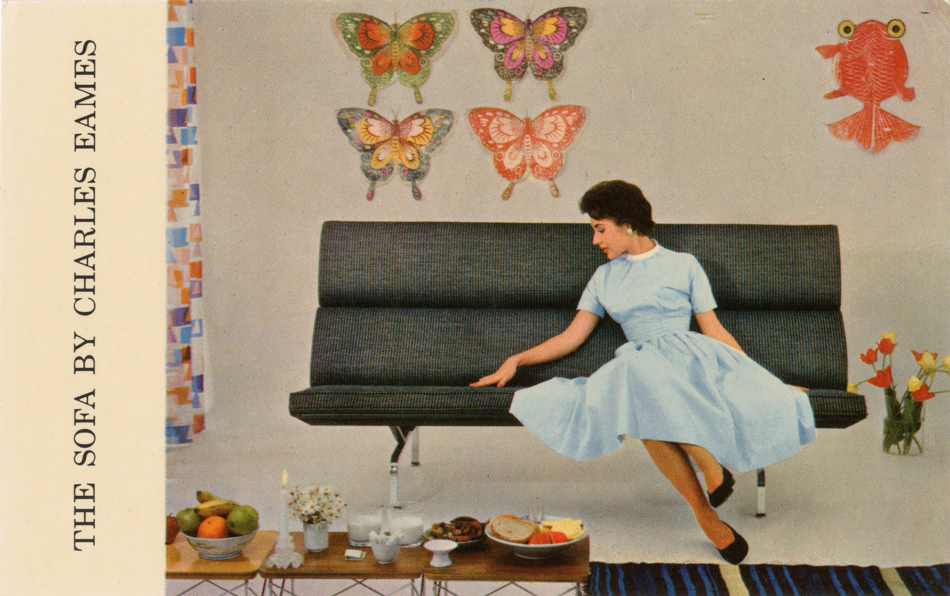 Herman Miller postcard for the Eames S-73 Sofa with Alexander Girard upholstery, set among paper kites and Eames LTR tables.