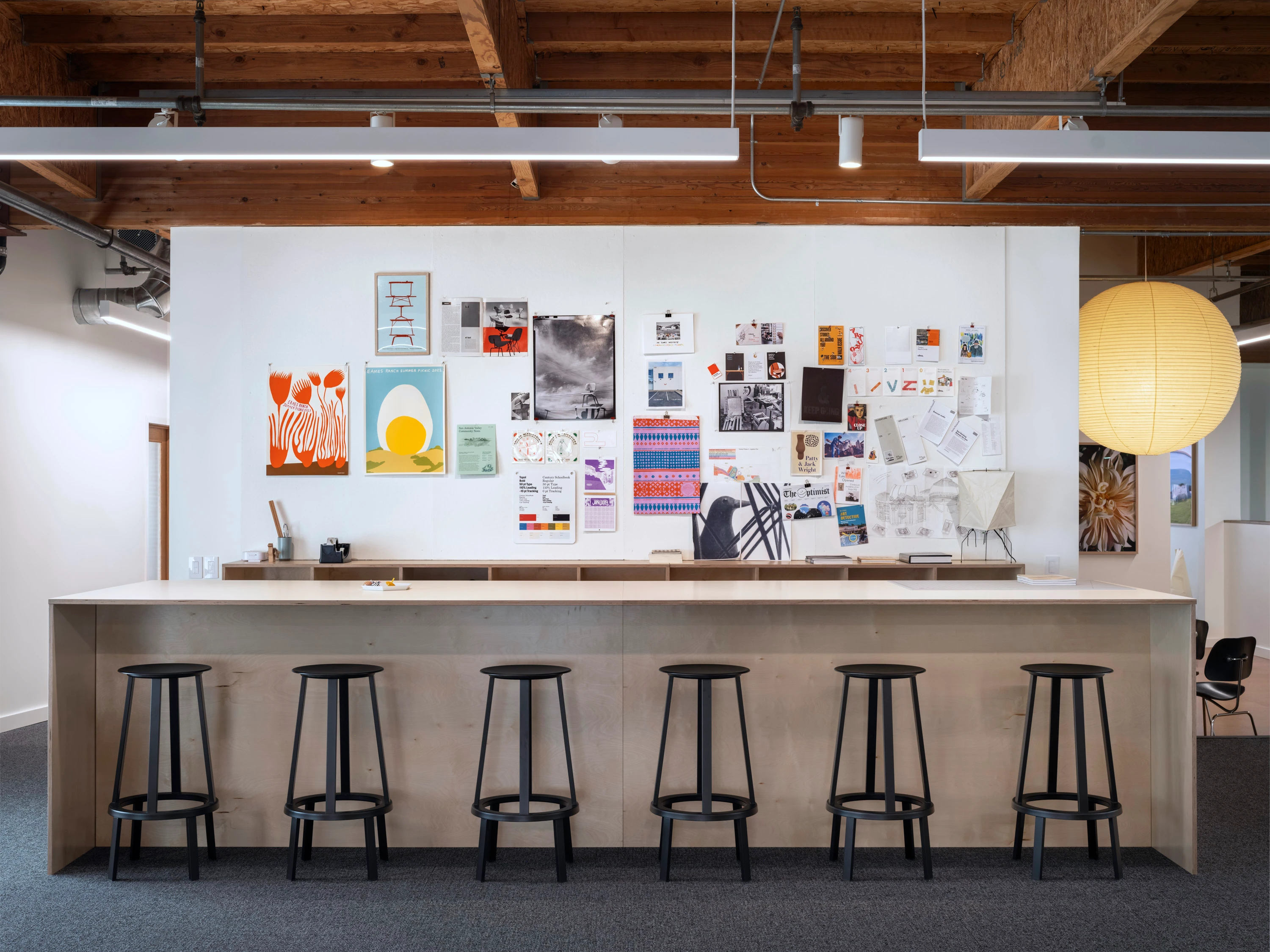 The island with stools on the mezzanine at the Eames Institute's Richmond offices