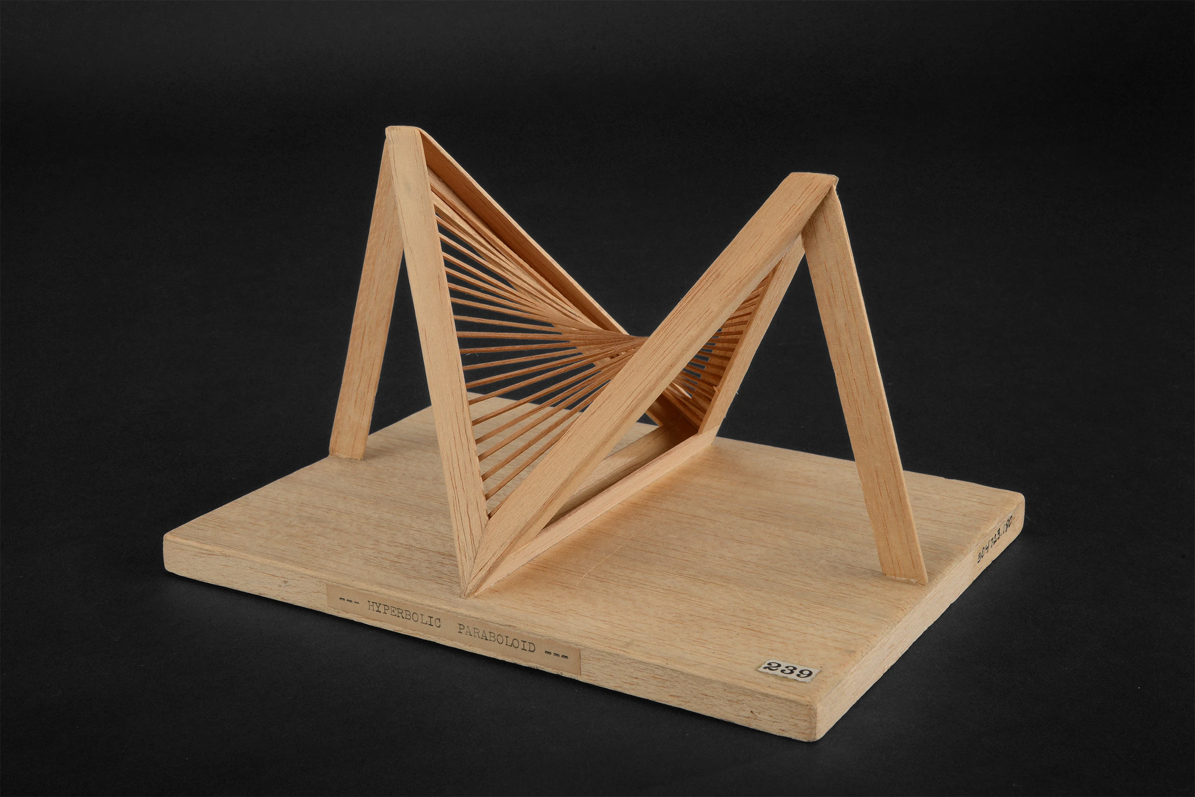 Side view of an intricate wooden model of a hyperbolic paraboloid by Robert Chaffe.