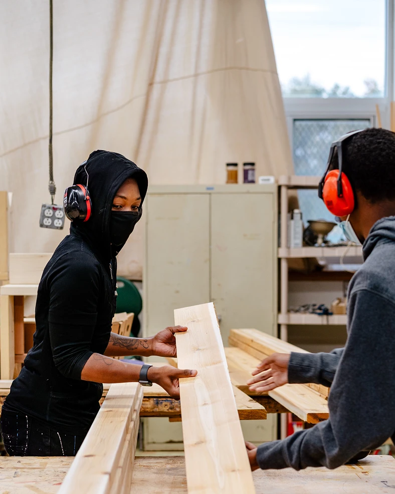 Students at the Brightmoor Maker Space milling wood in the workshop, Kazam! Magazine.
