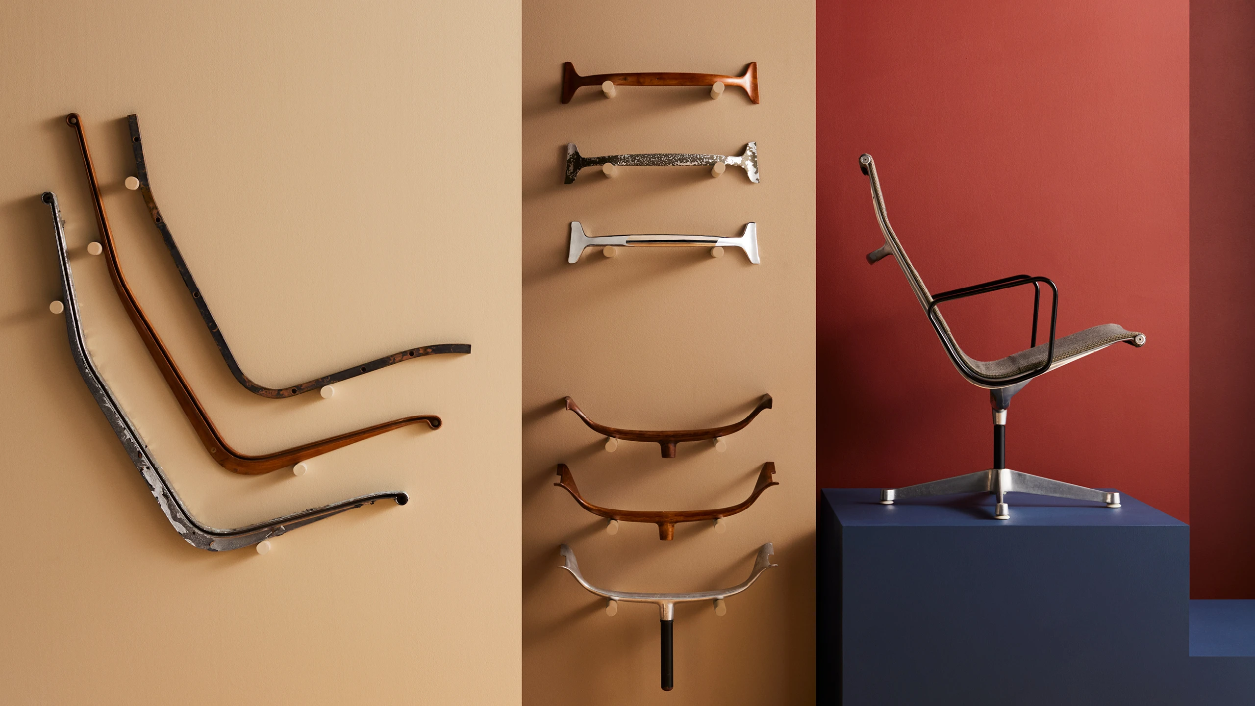Eames Aluminum Group chair side rails and antlers displayed against a backdrop of colorful walls.