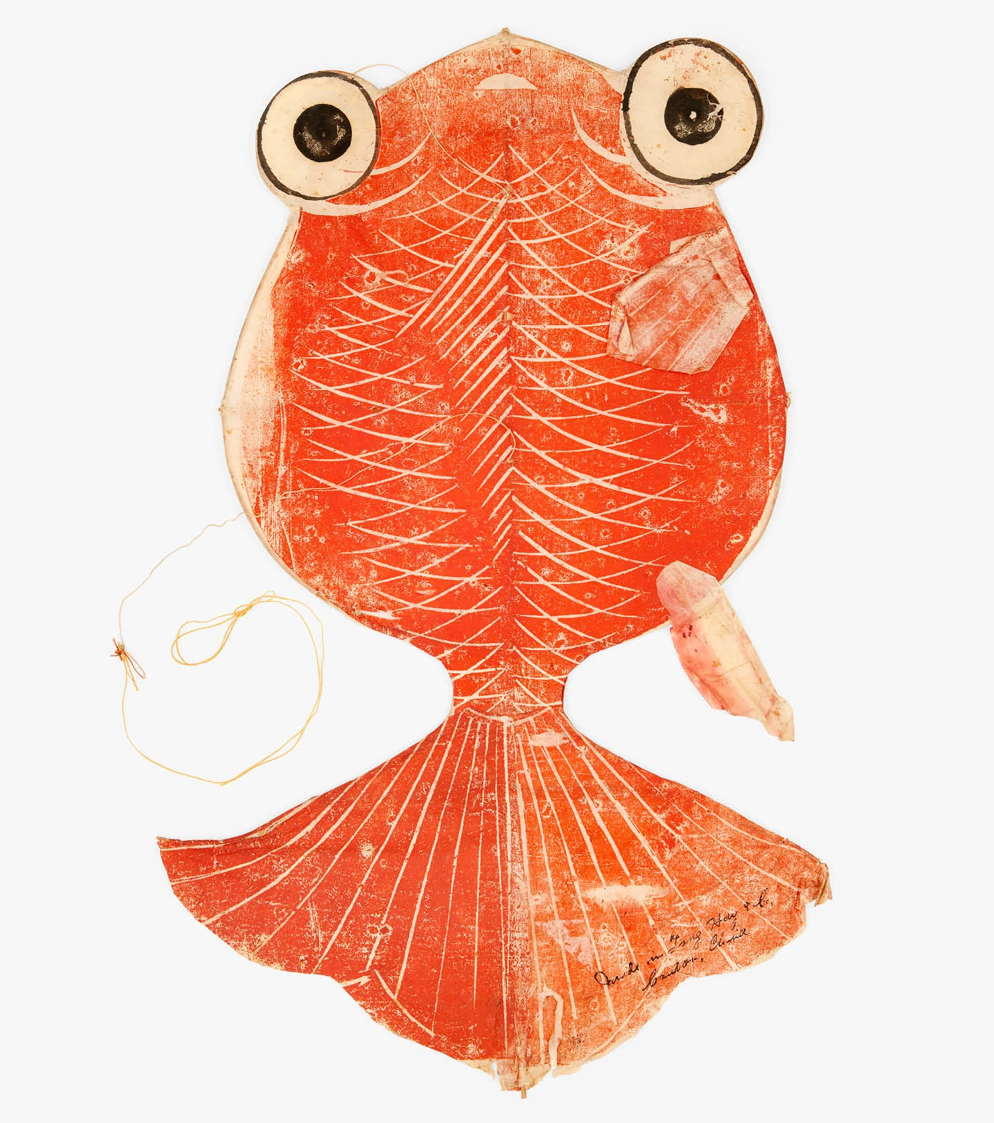 A colorful and playful goldfish shaped kite collected by the Eameses and displayed in their home and studio.