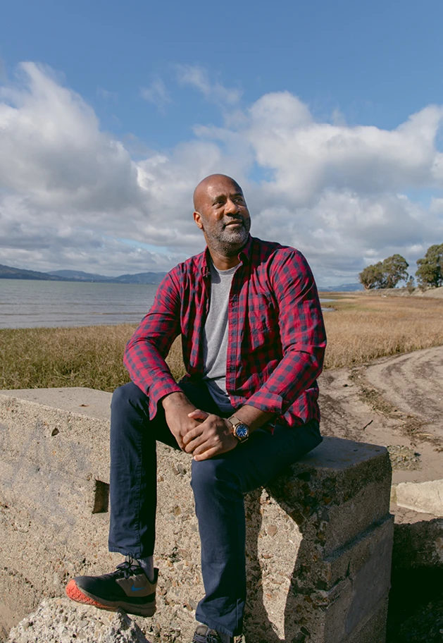 Maurice Woods, founder of creative mentorship program—Inneract Project, sitting in an outdoor setting.
