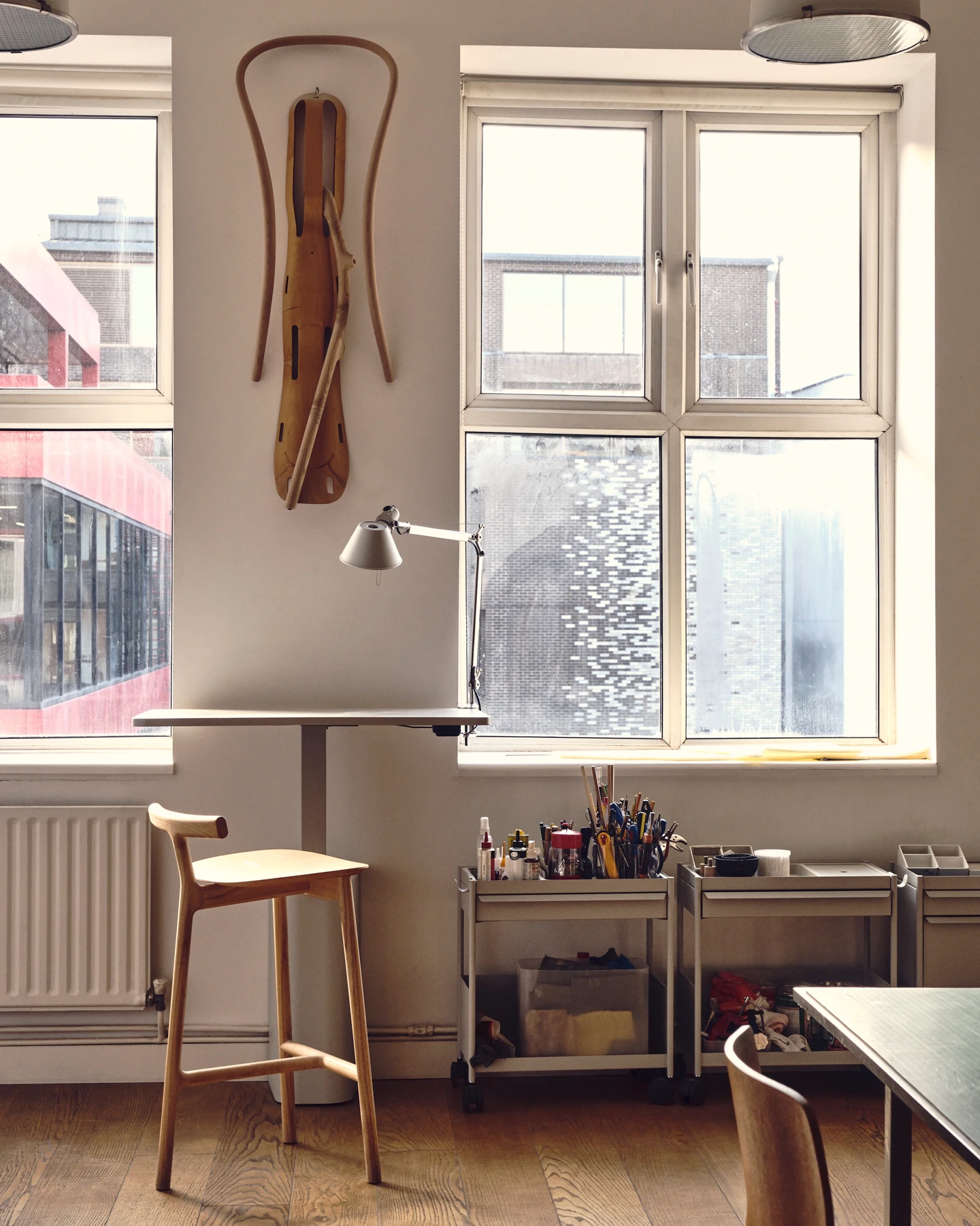 Small corner of design studio Industrial Facility featuring a work table, chair, and tools—Kazam! Magazine.