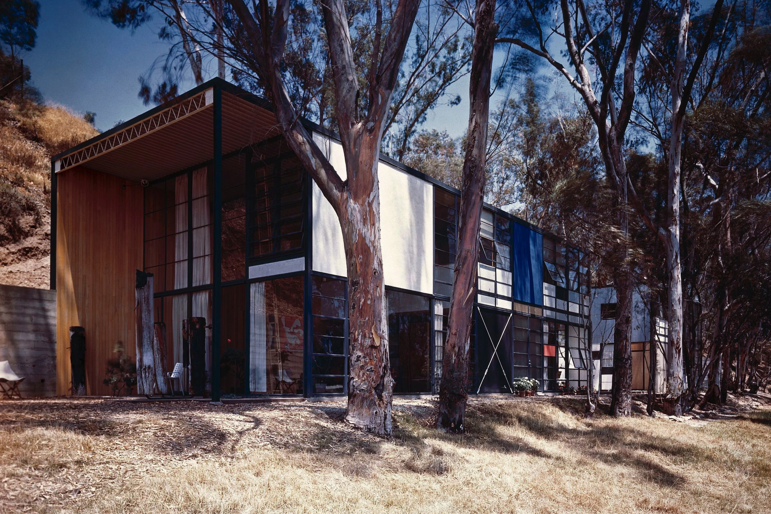 Eames Case Study House 8 exterior featuring large windows and colored panels that reflect the modernist design approach.