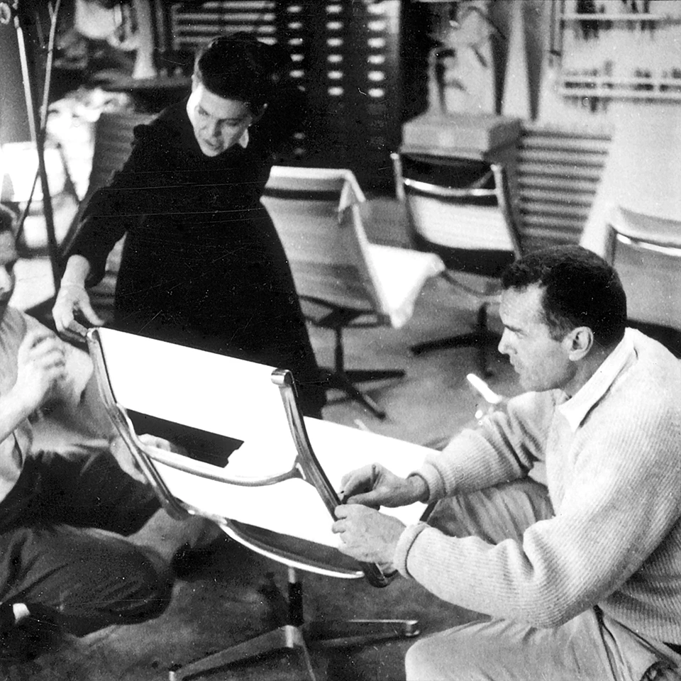 Ray and Charles Eames work on upholstery details for the Eames Aluminum Group furniture collection. Image © Eames Office, LLC
