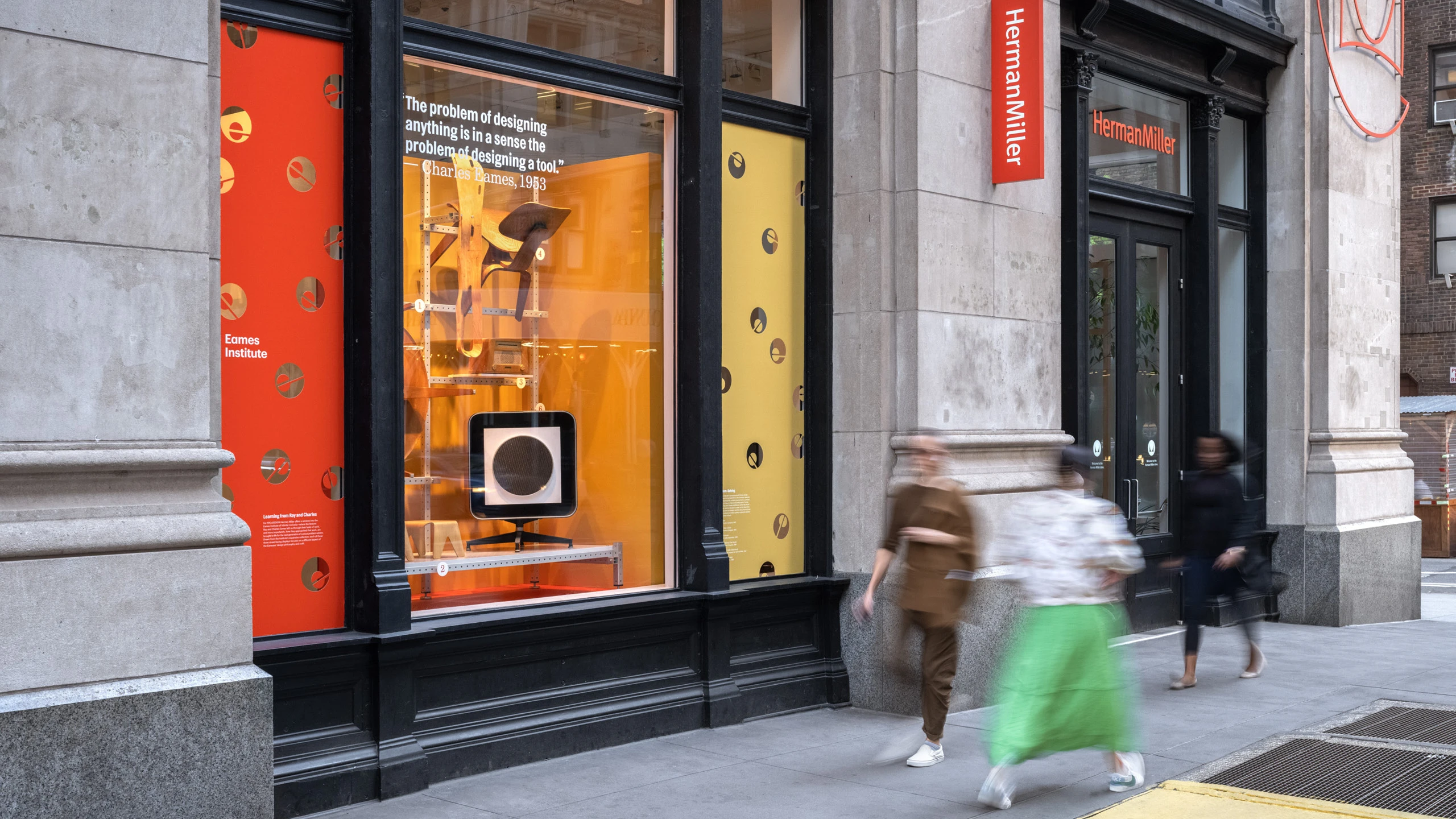 Herman Miller window display featuring Eames molded plywood designs such as a child’s chair and stool, an ash dining chair, and a walnut coffee table.